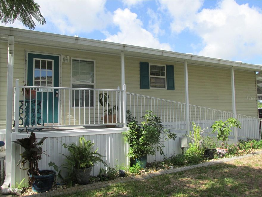 Fully furnished and turnkey, this 2/2 LAKE SIDE manufactured home is move-in ready!  It's located in the much-loved 55+ community of Saddlebag Lake Resort, where you OWN the land, and the HOA dues are LOW! The kitchen has custom made maple wood cabinets and quartz counter tops, with an island that doubles as a breakfast nook. You will love the walk-in marble shower, and the new flooring throughout the home.  No expense has been spared in this home, situated on a concrete pad with storage underneath, a two-car carport and covered ramp for easy access.  There's even a golf cart that stays for the new owner.  Start your days in the living room overlooking the lake for breathtaking views, and end it with lake side grilling on the open patio.  Access the lake right from your back yard and go boating and fishing to your heart's content!  Enjoy all the resort has to offer, and join the club of your choice, there's something to do every day!  Whether you like to play shuffleboard or horseshoes, a friendly game of pool, tennis or pickleball, or just want to relax in the hot tub or take a dip in the pool, it's all here for you. Saddlebag Lake Resort is pet friendly, and there's a dog park at the back of the community with a brand new dog wash station.  You won't even have to leave the resort to get your mail, there's a post office onsite.  You owe it to yourself to check this out before it's gone, so call now for your private tour!