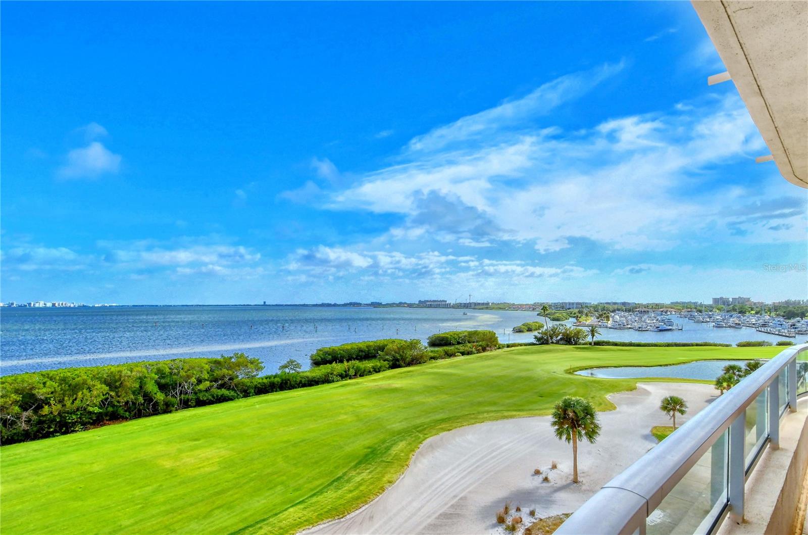 Step into a world of panoramic beauty, where Sarasota Bay, the Harbourside golf course, and the sparkling downtown skyline take center stage. This Antigua residence at Grand Bay offers a stunning vantage point, perfectly positioned on the corner of Building III. The sun-drenched interior spans nearly 3,000 square feet, providing a spacious and inviting retreat. Start your journey by taking the residents-only elevator from the secure, under-building parking area, which whisks you directly up to the residence's private foyer entry. As you step inside, your eyes will be drawn to the floor-to-ceiling glass sliders that open to the wraparound terrace, showcasing breathtaking views. The neutral palette enhances the light and bright atmosphere, creating an inviting ambiance that flows throughout. Oversized diagonal Travertine tile flooring connects the formal dining area seamlessly to the living room, offering a sense of continuity and elegance. The eat-in kitchen is a delightful space filled with natural southern light, thanks to the glass sliders that lead out to the second terrace. With its island, double built-in ovens, and charming dining nook, it's a place to enjoy lavish views and culinary treats. The master suite is a tranquil haven, positioned in the northeast corner for ultimate privacy. This retreat offers its own private access to the bayfront terrace, along with his/her bathrooms and generously sized walk-in closet. Two guest bedroom suites, one of which is currently being used as a den, are thoughtfully arranged in a split plan to create a serene experience for overnight guests. Grand Bay is an exceptional inspired neighborhood, tucked behind the exclusive gates of Bay Isles. Here, you'll find proximity to the best that Longboat Key and Sarasota have to offer, along with a host of amenities that cater to a life well-lived. Residents enjoy the convenience of on-site management, security, and a 24-hour manned guard gate. But it's the resort-style amenities that truly set Grand Bay apart. Stay active and fit in the state-of-the-art fitness center, perfect your game on professional-grade tennis courts, or simply relax on the bayside sundeck with its inviting lounging and dining areas. Take a dip in the heated swimming pools or unwind in the spa, then fire up the grill at one of the stations. The lively clubhouse offers a variety of activities. Deeded access to the private Bay Isles Beach Club is just a short bike ride away, providing the perfect finishing touch to this sought-after lifestyle. Room Feature: Linen Closet In Bath (Primary Bedroom).