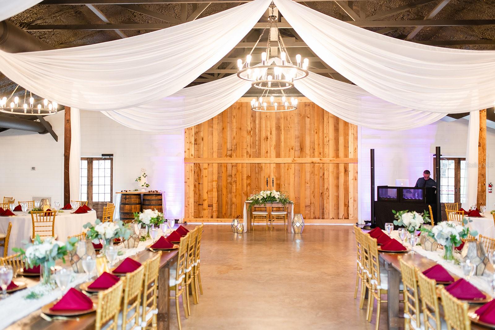 Welcome to Moss Estates. A captivating wedding venue nestled on 20+/- acres of breathtaking land in Eustis, FL. This isn’t just a property for sale; it’s a thriving business built on a legacy of love, joy, and celebration. The owner’s top priority is finding a buyer who will honor this legacy, ensuring a smooth transition with all future bookings and preserving Moss Estates as a premier wedding destination.
With over 80 weddings annually over the past two years, Moss Estates is a profitable, well-loved venue with room to grow. For the right buyer, this is an opportunity to not only invest in a successful business but to step into a beloved role at the heart of life’s most cherished moments.
ELEGANT FACILITIES:
BRIDAL SUITE: 960 sq. ft. of refined comfort with a private pool. This suite offers brides and their parties a luxurious, private retreat.
GROOMS QUARTER'S: A dedicated space complete with a game room, pool table, and outdoor putting green—combining style, relaxation, and fun.
CEREMONY SITE: A scenic spot beneath a majestic oak tree, with vintage doors and paved seating for up to 150 guests—a beautiful backdrop for unforgettable vows.
THE TUXEDO BARN: A 3,000 sq. ft. air-conditioned barn with vintage Edison bulbs, chandeliers, and modern charm, ideal for receptions of up to 150 guests.
ADDITIONAL FEATURES:
The property includes a 3,818 sq. ft. owner’s residence that has 1930’s charm but was completely remodeled in 2019 with top of the line modern finishes and energy efficiency. Also included is a 3,000 sf garage, functional pole barn, and recently renovated restrooms. Moss Estates is fully equipped to host memorable, comfortable events.
A BUSINESS READY FOR EXPANSION:
Moss Estates is more than a venue—it’s a well-established, thriving business with clear pathways to growth. With its comprehensive facilities and undeniable charm, Moss Estates is set for even greater success and the possibility of performing more weddings annually.
Are you ready to be part of a legacy? For those who wish to carry on this tradition of excellence, Moss Estates offers the unique chance to embrace a business built on happiness and community. Schedule your private tour today and imagine your role in the future of Moss Estates.