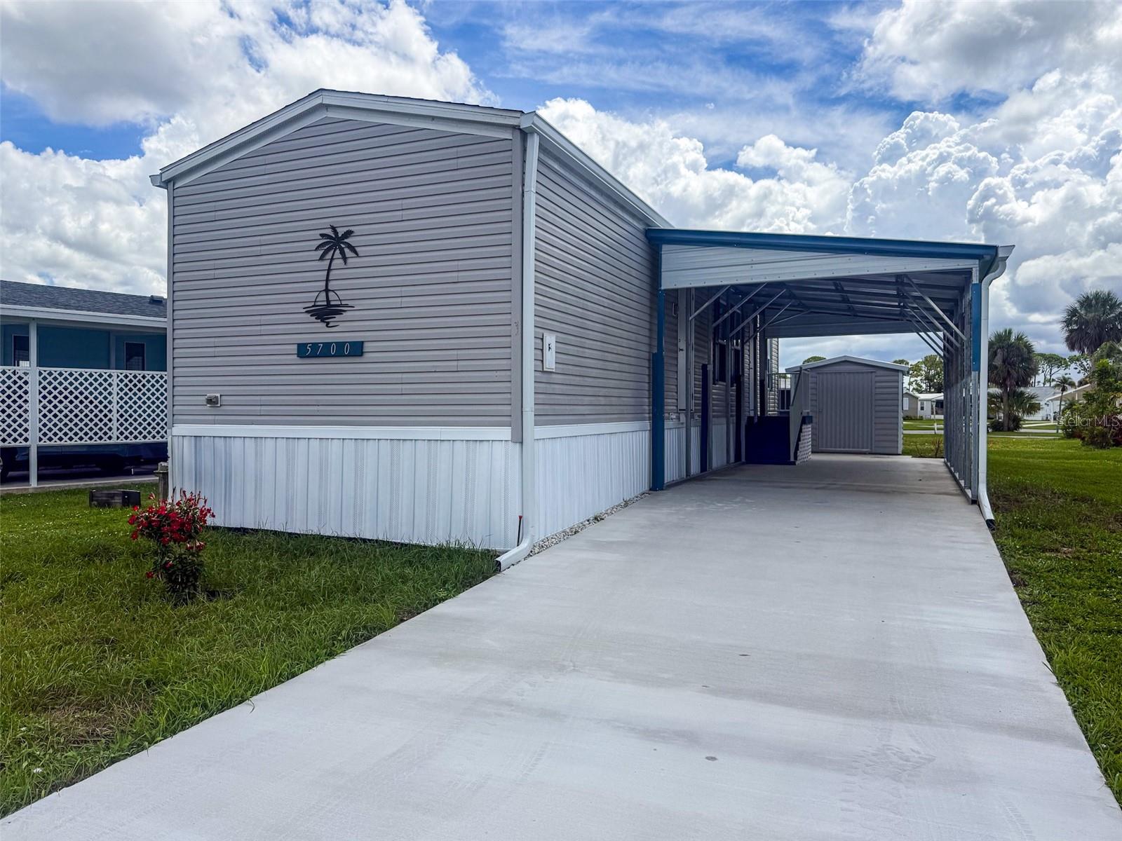 New construction 5700 Holiday Park Blvd, a deed restricted single wide manufactured home nestled in the highly desirable 55+ gated community of Holiday Park in North Port, Florida. This 0.09-acre home site offers the perfect opportunity to enjoy resort-style living year-round. Holiday Park features incredible amenities, including two community pools, tennis and pickleball courts, shuffleboard, a fitness center, clubhouse with activities, library, and much more. With no lot rent and low monthly fees included in your annual taxes, this lot is ideal for seasonal snowbirds or full-time residents looking for affordable and active adult living. This unit was designed on the interior to be super handicap accessible with an extra wide hallway and extra wide doors to a comedy a wheelchair. There is a attached steel carport and new shed installed for storage. This quaint community is just down the road from Wellen Park, a beautiful master community boasting a large downtown for everyone to enjoy with music every night from 6:00 to 10:00 and events throughout the month like the farmers market, car shows, etc. And the braves spring training stadium as well.