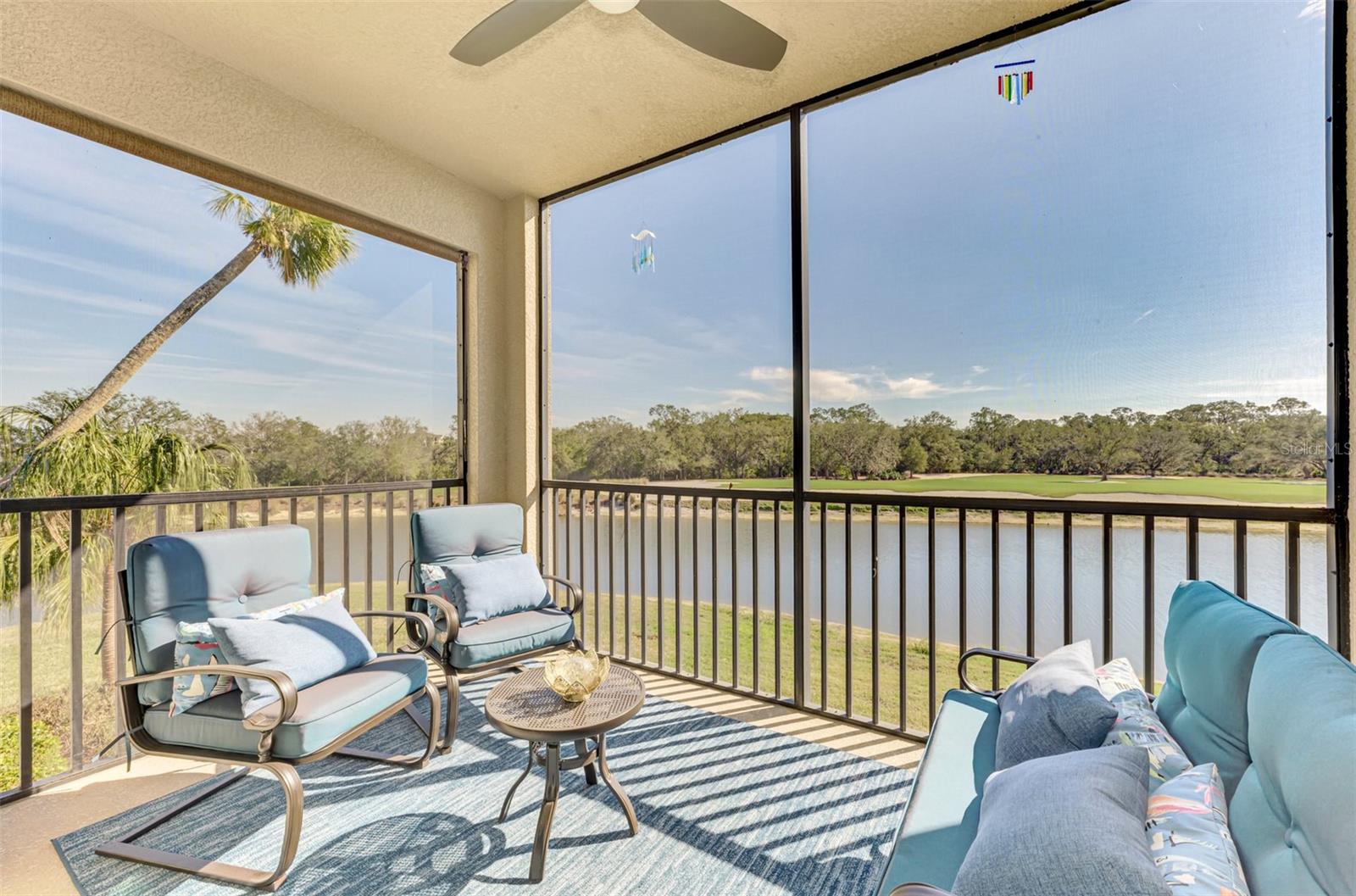 Price REDUCED– Don’t Miss This Opportunity!
Experience resort-style living in the heart of Lakewood Ranch National Golf & Country Club. This beautifully furnished, TURNKEY 2-bedroom, 2-bath Birkdale model is a highly sought-after end-unit on the second floor, offering panoramic views of the 11th hole on Commander’s Course, tranquil ponds, and protected nature preserves – all visible from the spacious screened lanai where you can unwind with breathtaking sunsets.
The open-concept layout features a chef’s kitchen with a large island, granite countertops, stainless steel appliances, and upgraded custom pull-out pantry drawers. The split-bedroom floorplan provides privacy, with a spacious primary suite offering walk-in closets and a walk-in shower. Guests will appreciate their own comfortable room and adjacent full bath. Additional conveniences include in-unit laundry, a covered parking space, and a private storage unit for bikes or gear.
Ideal for seasonal or year-round living, or an attractive investment property with 12-monthly rental potential per year. Lakewood National is a 24/7 guard-gated, maintenance-free community offering two Arnold Palmer-designed championship golf courses, a grand clubhouse, full-service spa, fine and casual dining, a cocktail bar, resort-style pool with lap lanes, tennis, pickleball, bocce, and a state-of-the-art fitness center with group classes. Residents also enjoy men’s and women’s lounges with locker rooms, on-site event space, and a full-time activities director.
Live where luxury meets lifestyle—schedule your showing today!