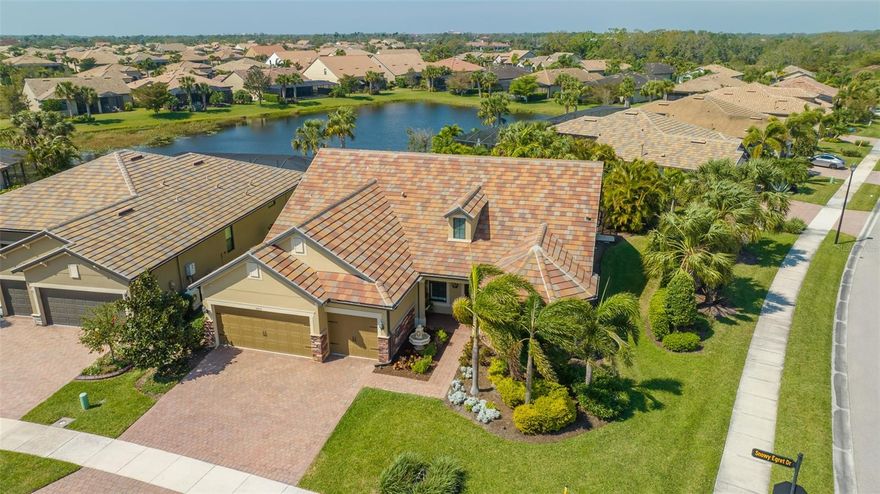 Model perfect Pinnacle floor plan in Sandhill Preserve on popular Palmer Ranch* Located on a oversize corner lot with lake views from the lanai* Amazing custom pebble tech saltwater pool/spa with unique water features both solar & gas heated with Travertine marble decking & outdoor kitchen with granite, 2 refrigerators & Lynx grill & Cypress ceiling*   This executive home is maintenance free & features a very open great room floorplan with 3 bedrooms, 3 full baths plus office/den with closet (could be 4th bedroom), glass double door entry  coffered ceiling * Gourmet kitchen with white cabinets with pull outs & soft close options, granite counters, Kitchen Aide Stainless appliances including 5 burner gas stove & reverse osmosis feature* Natural gas  throughout includes tankless hot water heater* Large neutral tiles on the diagonal through entire house except for 1 bedroom with carpet* One guest bedroom is ensuite* All hurricane impact windows & doors for low insurance* Custom Hunter Douglas Plantation shutters throughout* Whole house natural gas generator* 2 zone AC system* Custom millwork decor crown moldings, tray ceilings, wainscoting & also 8' interior doors* Spacious master suite, tray ceiling walk-in closet with custom organizer, master bath has large walk in shower* Front elevation is upgraded with stone accents* Expanded garage by 4 ft. has garage organizers & is ready for 3 cars* Paver brick driveway & walkway*  HOA maintains the grounds, trims trees & bushes, provides mulch, fertilizer, weed & insect control*  Sandhill Preserve is one of Palmer Ranch's newer communities with only 308 homes* The community features a community pool, jacuzzi, fitness center, pickle ball, club house, fire pit, barefoot bar area tennis & more. Located in the heart of Palmer Ranch just minutes from world famous Siesta Key beach, shopping, restaurants & Legacy bike trail*