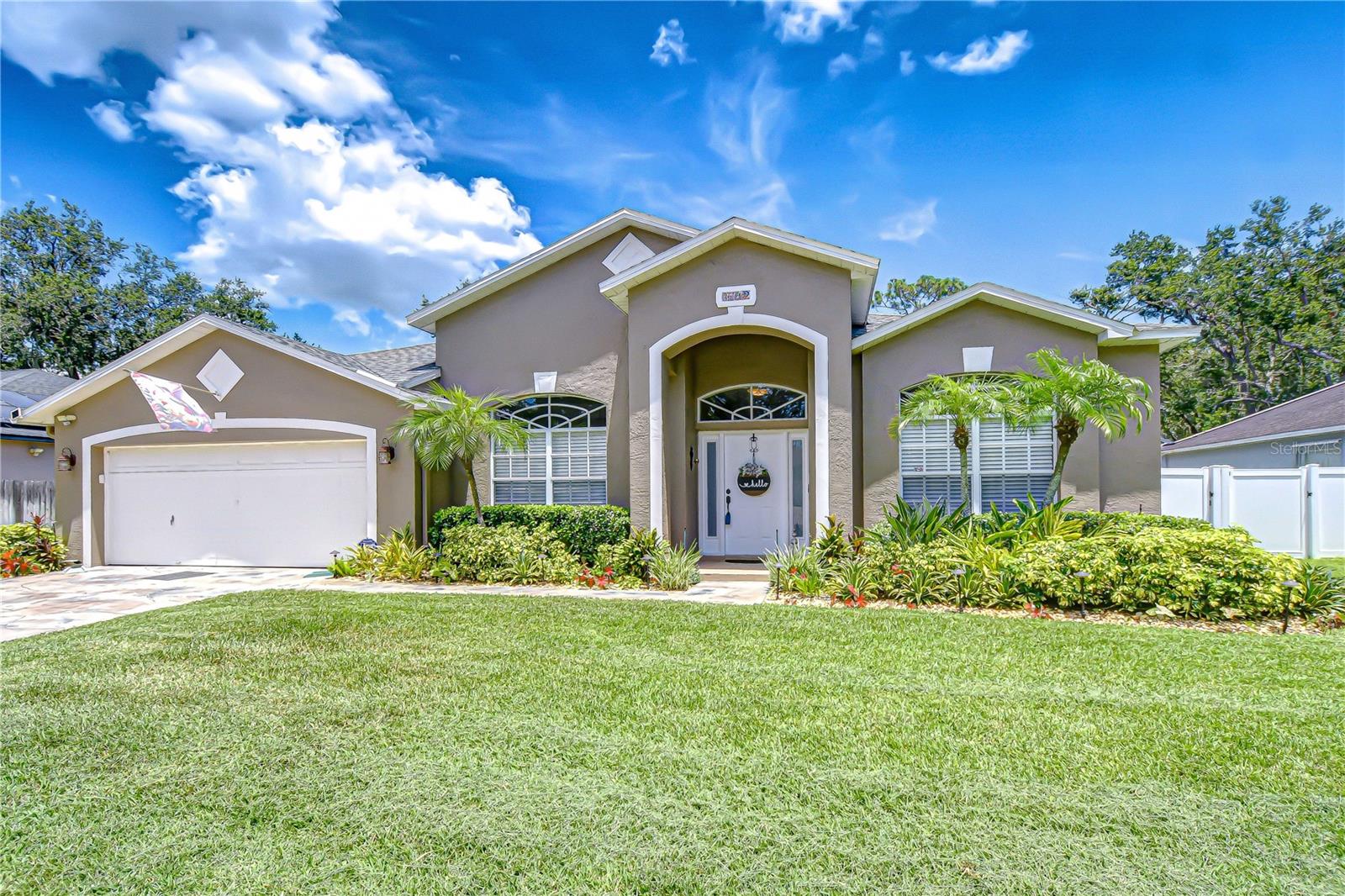 Welcome to Bloomingdale – a highly desirable neighborhood in Valrico, known for its scenic walking trails, parks, playgrounds, and the surrounding golf course for those who love an active lifestyle. Enjoy peace of mind with major updates already completed: Roof (2017), A/C (2020), Water Heater (2024), Fence (2025), and the pool was resurfaced and pavers added in 2020. This stunning home offers exceptional curb appeal with tropical landscaping and a welcoming front entry. Step inside to gorgeous wood floors and immediate views of your private backyard oasis! This spacious 4-bedroom, 2-bathroom pool home features a thoughtfully designed 3-way split floorplan with formal living and dining rooms that greet you upon entry. The oversized family room flows seamlessly to the screened lanai through sliding glass doors—perfect for easy indoor-outdoor living. The kitchen is a chef’s dream with a center island, bar seating, wine storage, and sleek stainless appliances. The private primary suite features a walk-in closet and spa-like bathroom with a raised soaking tub, dual vanities, and private access to the pool. On the opposite side of the home, you’ll find three additional bedrooms that share a beautifully remodeled full bath with direct lanai access—perfect for guests. Step outside to your fully fenced backyard, replaced in 2024, with mature trees, lush landscaping, and a soaring screened enclosure over the sparkling pool. Need extra storage? A spacious shed is ready for your tools or toys. Located just a short walk to Alafia Elementary and close to shopping, the YMCA, parks, and Bloomingdale’s 18-hole golf course—this is the Florida lifestyle you've been waiting for in one of Valrico’s most sought-after communities!