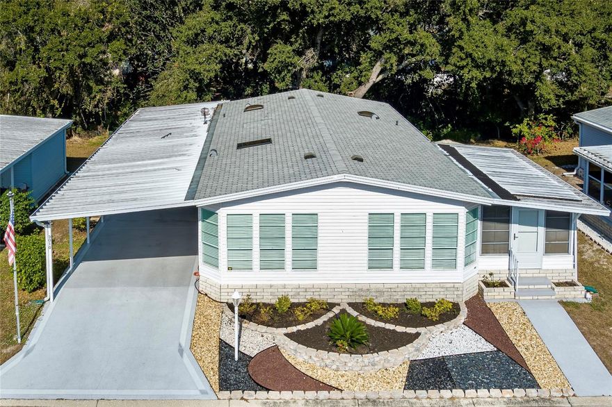 Exceptionally spacious double-wide that lives like a single-family home, featuring sheetrock walls, an open layout, and clean coastal décor. Immaculate, well maintained, and truly move-in ready.
Rare 14x20 garage plus covered carport for two vehicles provides excellent parking and storage. Major updates are already complete, including a new roof (2023), A/C (2024), water heater (2025), carpet (2023), paver patio (2025), refrigerator (2023), microwave (2025), and washer/dryer (2025).
With no co-op buy-in fee and no lot rent, this home offers outstanding affordability. The HOA fee adds even more value by covering water, sewer, trash, internet, cable, and yard maintenance.
A well-designed hardscaped front yard with decorative stone accents, curved raised planter beds, and clean concrete walkways creates standout curb appeal with a neat, coastal-inspired look that stays attractive year-round. Bright interior with vaulted ceilings, skylights, and large windows. The kitchen features a breakfast-bar island, ample storage, and included appliances. Spacious primary suite with double mirrored closets and ensuite bath, plus a comfortable guest bedroom, updated hall bath, and air-conditioned lanai. Home may be sold furnished.
Located in an active 55+ community with clubhouse, heated pool, and social activities. Pets welcome, rentals permitted, and convenient access to shopping, dining, major highways, and nearby Gulf beaches.