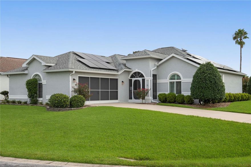 Welcome to this beautifully updated 3 bedroom, 2 bathroom home offering 1,822 square feet of under air living space on a spacious corner lot in the desirable Ocala Palms community. With nearly $80,000 in upgrades, including fully paid solar panels, this high efficiency home is designed for comfort and savings with exceptionally low electric bills. The screened front patio opens to soaring ceilings, elegant flooring, and an open floor plan. The kitchen is a showpiece with an oversized island, quartz countertops, stylish backsplash, and generous seating space, all flowing seamlessly into the great room, perfect for entertaining. The primary suite provides a private retreat with dual vanities, a soaking tub, and separate shower, plus the added benefit of a dedicated mini split system for personalized comfort. The second bedroom is generous in size with a deep closet and natural light, while the third bedroom, located at the front of the home with glass front doors, is ideal as an office or guest room. The enclosed lanai provides additional living space with a birdcage view of the backyard. Recent upgrades and features include a 2018 4 ton 17 SEER AC, 2015 roof, 2021 40 gallon water heater, Low E windows, plantation shutters, extra attic insulation, a transfer switch for a generator, and paid off 9.5KW solar panels. Ocala Palms is a gated golf community offering access to a clubhouse, restaurant, indoor and outdoor pools, golf, and a wide range of clubs and activities. This is a move in ready home with smart upgrades, modern comforts, and excellent energy efficiency.