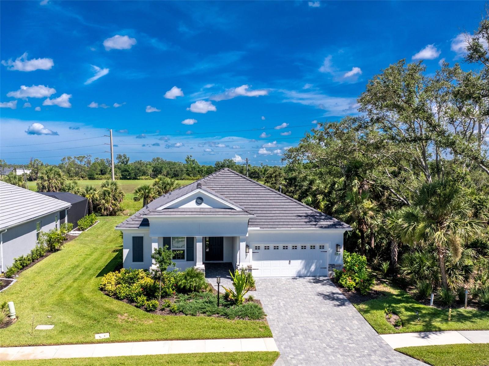 Experience Luxury Living at its finest with this immaculate 2023 Pool Home at Boca Royale Golf & Country Club! This stunning Endless Summer 3 design boasts 3 bedrooms, a flexible space, and a private pool, all nestled in the new section of this prestigious golfing community. The striking exterior features a multidimensional tile roof, paver driveway and walkway, stone accents, and elegant architectural details that create outstanding curb appeal. Inside, an open floor plan with tray ceilings highlights the gourmet kitchen, complete with quartz countertops, modern cabinetry, a walk-in pantry, and a custom wood vent hood over the gas cooktop. The kitchen flows seamlessly into the dining and living areas, perfect for entertaining. The primary suite is a true retreat, with a tray ceiling, two walk-in closets, and a luxurious en suite bathroom featuring a dual granite vanity, walk-in shower, and a window for natural light. Guest bedrooms share a stylish bathroom with a granite-topped vanity and walk-in shower. A versatile office/den with French doors can easily be transformed into a gym, hobby room, or extra guest space. Step outside through triple sliding glass doors and unwind in your own tropical oasis. The expansive paver lanai area surrounds the pool with a beautiful waterfall feature, ideal for relaxation. A convenient half bath, which also serves as a pool bath, and a laundry room with built-in cabinets and a sink add extra functionality. Did I mention this home is in an X flood zone and flood insurance is not required? This home also comes equipped with smart home technology to control your security system, A/C, and door locks remotely. As a resident of Boca Royale, you'll enjoy resort-style amenities, including lawn care, a heated/cooled community pool, tiki bar, spa, fitness center, and social club. Separate memberships are available for golf, tennis, and pickleball. The clubhouse is a hub for community activities, and with quick access to Venice, Englewood, and Wellen Park, you're just minutes from beaches, shopping, dining, and medical facilities. Schedule your tour today and make this dream home yours!