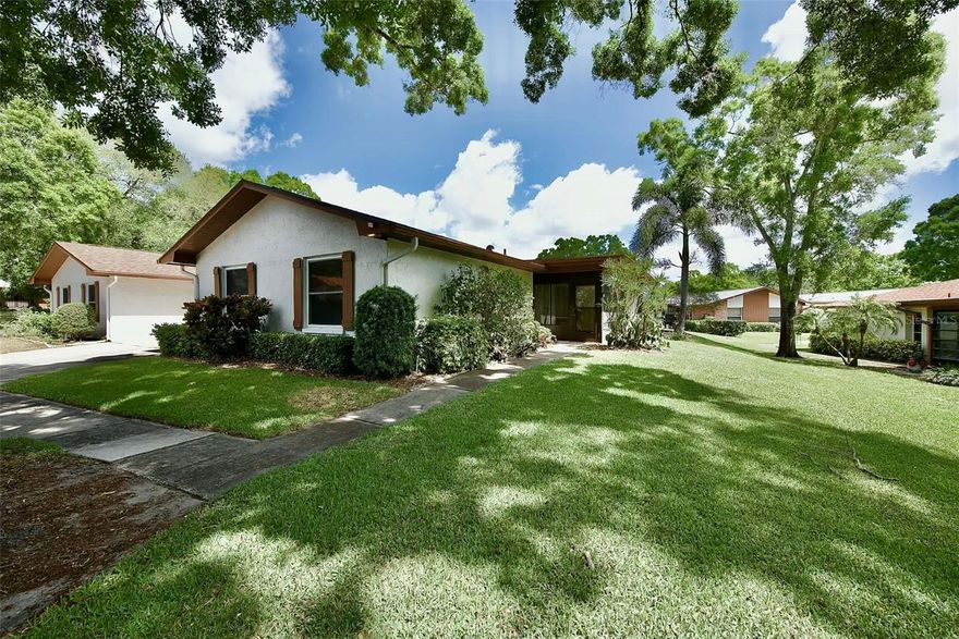 The BEST location for this lovely residence.! QUIET..PRIVATE...OFF THE STREET! Convenient attached garage.  Scenic tree lined ravine views.  PLUS SPACIOUS lanai... Lanai is heated and cooled and adds 120 sq ft of living space.  Top quality ceramic tile throughout.... Large sunny SKYLIGHT in Diningroom.  This 2 bedroom, 2 full bath, master has an en-suite bath,  with one car garage offers PRIDE OF OWNERSHIP and QUALITY care.  A new bathtub coating in 2nd bath. Roof Oct 2025, Newer mechanicals such as Air Conditioning, Water Heater, Electrical Panel.   Upgraded DOUBLE PANE windows IN BEDROOMS...All other appliances included are the Refrigerator, Stove, Dishwasher, Washer/Dryer LOCATED IN GARAGE.  Very economical Electric... Highland Lakes is a 55+ Golf Course Community with 3 FREE Executive Golf Courses, loads of Clubs, Activities SUCH A PICKELBALL, TENNIS, CERAMICS, WOODWORKING, PHOTOGRAPHY,  BOCCO BALL, RV BOAT STORAGE with 2 Heated Pools, a Hot Tub too at Main Clubhouse. Pool tables and library to enjoy.. Stay as BUSY as you want or not! Sign up for Pontoon Boat ride on Lake Tarpon with lunch at Tarpon Turtle....IMAGINE YOURSELF SIPPING ON THAT FAVORITE DRINK FROM YOUR COZY TEMPERATURE CONTROLLED LANAI OVERLOOKING OPEN SPACE WITH THAT SPECIAL SOMEONE.....  Come see this quiet GREAT GOLF COMMUNITY TODAY.....