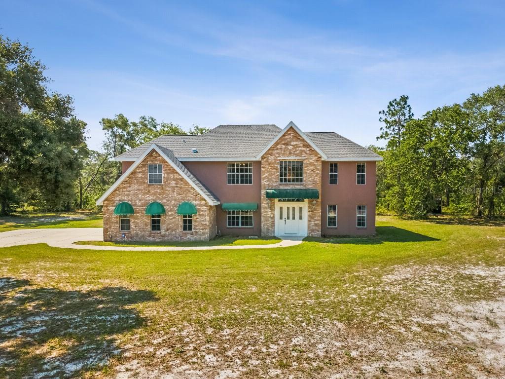 Welcome to your secluded estate sanctuary! Surrounded by privacy, with almost 2 1/2 acres of unrestricted property, this luxury custom build home offers all the amenities for a large family or business owner. Zoning allows additional buildings for toys and equipment, or even a 2nd home! Featuring double staircases, 2 gas fireplaces, plenty of closets and storage, an office/library, formal living and dining rooms, 4 oversized bedrooms, and a large screened-in pool with full outdoor bathroom. The property features an impressive entranceway and is set back from the main road. Approaching the home you'll find an expansive parking area with a 3 car garage including laundry room. You will immediately notice the build quality with solid doors, gas appliances, oversized bedrooms, numerous expansive closets, and custom features throughout. A grand estate nestled in seclusion with unlimited possibilities for the family, executive, or business owner, this home is one of a kind.