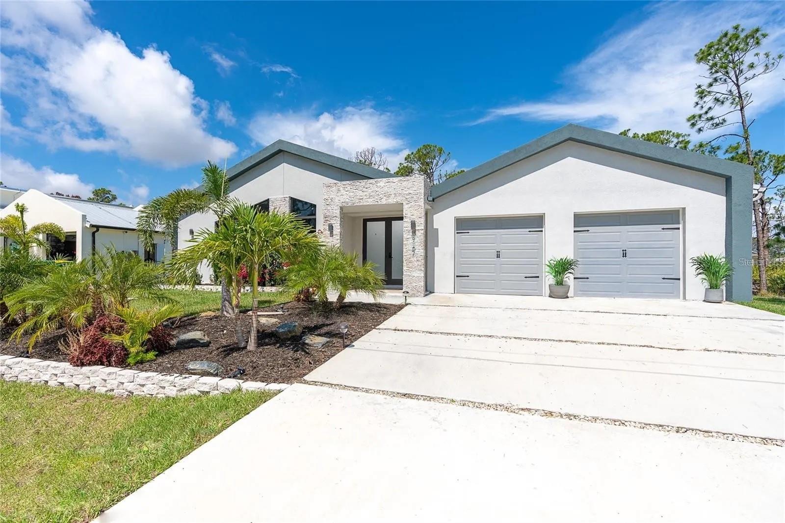Discover unparalleled luxury in our exquisite steel frame home, where sleek modern style meets the sunny backdrop of Southwest Florida. Completed in 2021, this single-level sanctuary embodies 21st-century design and comfort. Nestled in a quiet, pristine neighborhood, it offers a serene and clean environment. With 3 bedrooms, 2.5 baths, and a 2-car garage, this home also features dual covered lanai areas. The open floor plan seamlessly combines the living and dining areas. Relax on the covered patio with coffee and cocktails or unwind on the modular sofa in the living room, enhanced by an electric fireplace insert for added ambiance. The kitchen, adorned with stainless steel appliances, boasts a stunning quartz island with sleek French glass doors and expansive windows, creating a seamless connection between indoors and outdoors. Tile flooring extends throughout the home, complemented by a metal roof and high-impact windows. Bathrooms showcase a tile shower, quartz countertops, LED mirrors, and a dual sink vanity. The custom interior features elegant decor and high-grade furnishings, while ample windows allow for abundant natural lighting. Private outdoor spaces let you and your guests enjoy the blue skies and sunshine. Conveniently situated close to recreational attractions, including golf courses at Rotonda West, Boca Grande, and Manasota Key beaches. A Publix grocery store and supermarket are just 1.5 miles away, ensuring that essentials are easily accessible