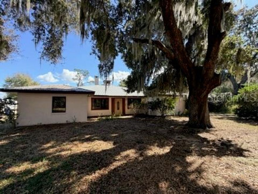 Short Sale. Welcome to your Florida oasis at 30 Placid Oaks Drive, Lake Placid, FL 33852! Nestled on a spacious 1.1-acre parcel in the tranquil Placid Oaks neighborhood, this charming single-story residence built in 1987 combines comfort, privacy, and timeless appeal in a picturesque natural setting. Approaching the home, you’re greeted by lush oak hammock landscaping and the inviting presence of a generous front porch — the perfect spot for your morning coffee or greeting guests. Inside, the thoughtfully laid-out floor plan features 3 bedrooms and 2.5 baths, with approximately 2,565 sq ft of interior living space. Large windows and an open flow create an airy, light-filled ambiance throughout, while functional living areas provide comfortable day-to-day living and space for entertaining. Step outside to your private backyard sanctuary — a screened-in lanai opens to a caged, in-ground saltwater heated pool, ideal for year-round enjoyment and low-maintenance Florida living. Imagine relaxing poolside under the sun, hosting weekend barbecues with friends, or simply unwinding in the peaceful setting surrounded by nature. Enhancing the property’s utility and appeal is a substantial workshop with an attached carport and pole barn, offering ample space for hobbies, storage, or projects. Beautifully landscaped yard featuring productive fruit trees, including 2–3 avocado, mango, and one loquat tree. With no HOA restrictions, this home provides flexibility and freedom while still being close to the lakes, shopping, dining, and recreational opportunities that make Lake Placid such a desirable place to live.