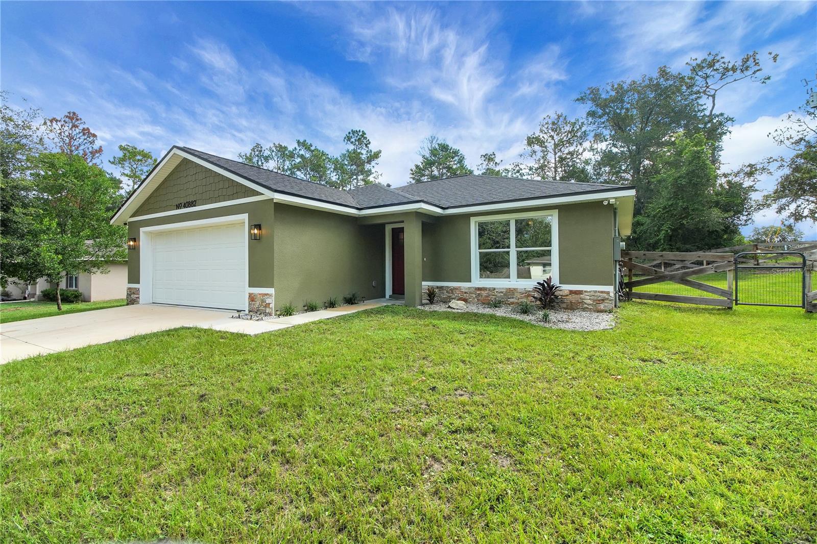Peace and Tranquility await! Imagine arriving home each day to your own tranquil haven where comfort, modern elegance and thoughtful design blend to create a lifestyle you've dreamed of. Nestled on a spacious .28-acre lot, this beautifully maintained, two-year-old, one owner home welcomes you. Step inside and discover why this home stands apart. You will appreciate the meticulous care that has gone into every detail. The open-concept living, dining and kitchen area forms the vibrant heart of the home - a bright, airy apace perfect for intimate family dinners, lively gathering with friends or a quiet morning coffee on the back patio as sunlight streams through. The kitchen is artfully equipped with gleaming stainless-steel appliances that invite culinary creativity. Sleek quartz countertops provide ample prep space and the large closet pantry tucked conveniently in the hallway ensures all your ingredients and gadgets are within arm's reach. Whether you're whipping up a quick breakfast or hosting a gourmet dinner, this kitchen is designed to inspire. Just off the living area, a laundry closet offers both practicality and discretion allowing you to keep up with daily tasks without sacrificing style or flow. Retreat to your private sanctuary in the spacious primary suite, where luxury and function intertwine. The primary bath features dual vanities set in elegant quartz, a generous walk-in shower and a walk-in closet tailored for ease and organization. Two additional bedrooms-each comfortably sized-offer versatility and space for family, guests, a home office or a creative studio. With a second full bath just across the hall mornings run smoothly and guests feel right at home. Step outside and be enveloped by the serenity and security of your fully fenced backyard oasis. There is ample space for children or pets to play, for gardening dreams to blossom or for simply soaking up the Florida sunshine in privacy. Dual gates on one side and a single gate on the other offer easy access for all your outdoor needs, while an irrigation system in both the front and rear yards keeps your landscape lush and green with minimal effort. Enjoy pure, refreshing water throughout your home thanks to the state-of-the-art RainSoft whole house water filtration system--a thoughtful touch that elevates daily living. Beyond your property lines adventure and convenience await. Cadwell Park, just minutes away, offers spaces to play, picnic and connect with neighbors. When the mood strikes for a bigger escape, you're just over an hour from sandy Atlantic beaches or the excitement of Orlando's theme parks-a perfect blend of relaxation and adventure always within reach. This is more than a house; it's a place to write your story. Picture family gatherings in the open living space, summer barbecues under the blue sky, quiet evenings unwinding in your private suite and weekends spent exploring all the area has to offer. Schedule your private tour today and experience firsthand the harmony, comfort and inspiration that await you here.
