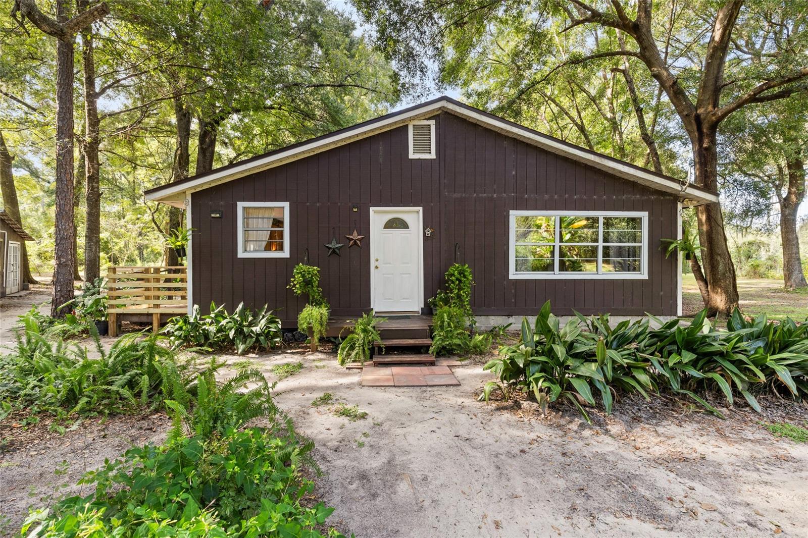 Enjoy peaceful country living on this amazing 5-acre property, complete with a private nature trail encircling the land. The property is fully fenced and features several raised garden beds, a detached storage shed, and an outdoor shower—perfect after gardening or yard work.
The home has been thoughtfully updated with a brand new roof, 3 energy-efficient mini-splits for zoned heating and cooling, a new water heater, and an electrical panel upgraded with 220 power.
Wildlife lovers will enjoy frequent visits from deer and turkey, while outdoor enthusiasts will love being just minutes from Watermelon Pond, where you can fish, kayak, enjoy “Sunday Funday” water sports, or explore nearby horseback riding trails. Whether gardening or enjoying fresh fruit from the variety of fruit trees (citrus trees, mulberry trees, moringa and a couple loquat trees, to name a few), this property is set up as the perfect homestead. This unique lot offers the perfect blend of tranquility, recreation, and convenient updates. Nestled just 10 minutes from downtown Newberry and close to all modern conveniences such as Publix and restaurants, you don’t want to miss the chance to make it yours!