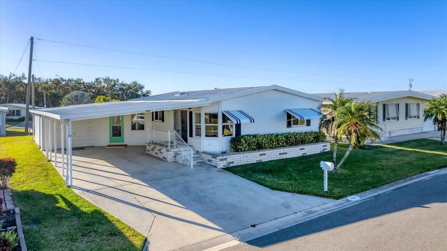 Welcome to Tidevue Estates, a desirable 55+ land-owned community! This move-in ready, fully furnished home offers comfort, style, and Florida charm. Rarely avaiable this home has a ONE CAR GARAGE which can also be used as a workshop or art studio. Featuring laminate flooring throughout, updated windows, and ceiling fans with lights in every room, this bright and airy home truly shines. The spacious Florida room invites natural light and is perfect for relaxing or entertaining. Enjoy a welcoming foyer entry with space for an office. The kitchen features Corian countertops, neutral cabinetry, and a skylight for extra brightness. The dining room includes built-in storage, and the living room offers a glass slider leading to the open front porch plus an electric fireplace for cozy ambiance. The primary bedroom features a walk-in closet and updated ensuite bathroom with a walk-in shower. Exterior highlights include a garage, double carport, and beautiful curb appeal. This home blends practicality with modern updates — bring your toothbrush and start living the Florida lifestyle today! Low HOA of only $600 annually. Pets are not permitted. Plenty of activities to keep you busy in this community. Take a water aerobics class in the solar-heated community pool or work on your tan. The community library has free WI-FI connection. Updated fitness center. Meet friends and make new ones for a game of indoor pickleball, bocce ball, or shuffleboard. Join the Golf League. Take a bike or golf cart ride to Veteran's Park to watch the wildlife and sunset. Ellenton Premium Outlet Mall, restaurants, and medical facilities are just minutes away. Easy access to I-75. Not to mention a short drive to our beautiful Gulf Beaches.