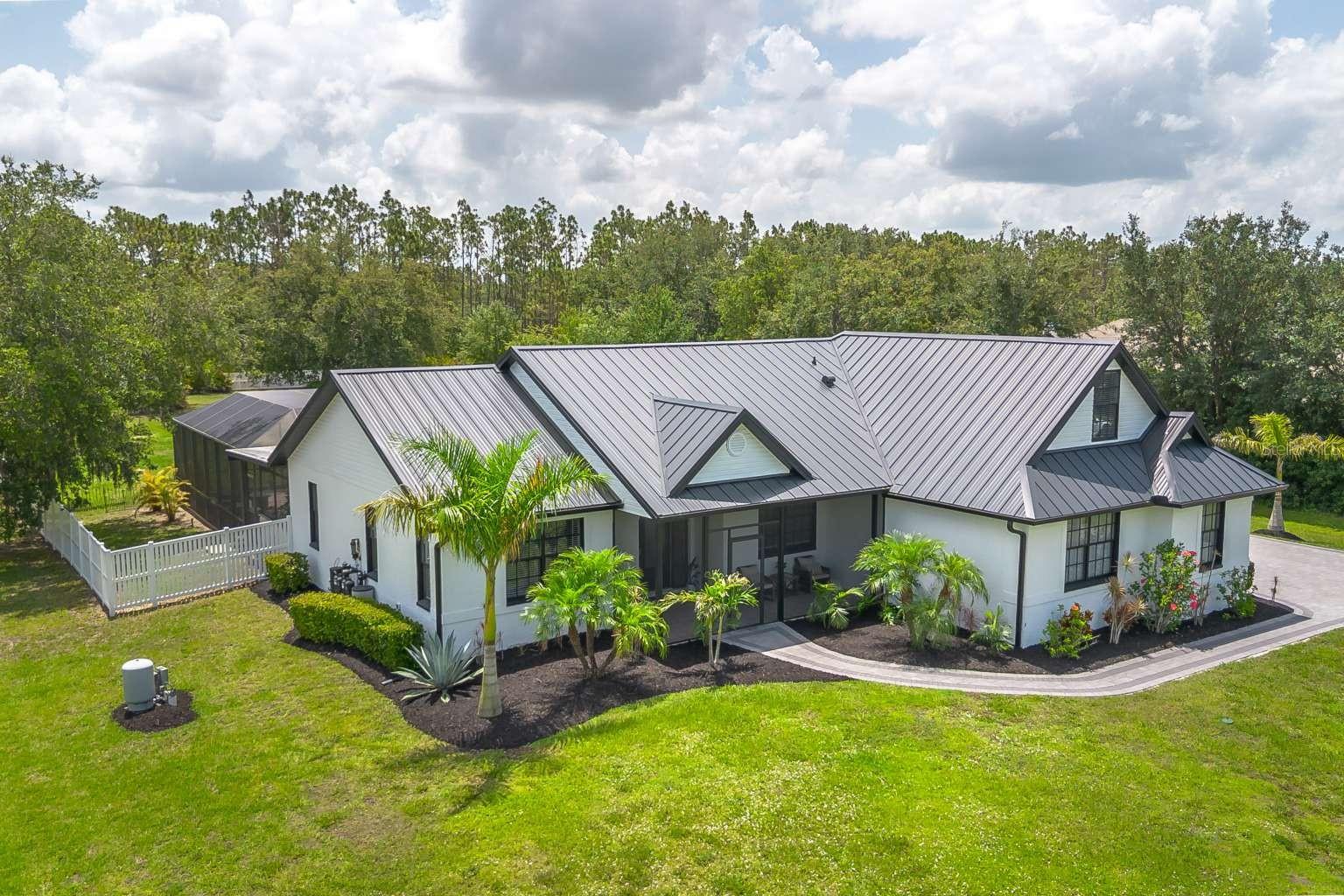 BACK ON MARKET! Buyer’s financing fell through. This hot property had multiple offers and went under contract days after the open house. Don’t miss your chance! Modern Farmhouse Charm in Panther Ridge Highlands! Discover a rare gem in the serene Highlands at Panther Ridge, where rural tranquility meets modern comfort on a hard-to-find 1.18-acre lot. Nestled in a quiet neighborhood of just 20 homes with no through road, this 3-bedroom, 2-bathroom home, plus a versatile bonus room upstairs, offers unmatched privacy and generous space between neighbors. Thoughtfully transformed with over $130,000 in upgrades over the past three years, it blends Chip and Joanna Gaines-inspired style with everyday functionality. It’s more than a house, it’s a warm, inviting home ready for your story. The new paver driveway and walkway create an instant sense of charm. Inside, the open concept layout flows seamlessly to a stunning paver pool area, showcasing a captivating rock waterfall with multiple water elements, a spacious lanai, and all new pool equipment replaced three years ago, complete with a newly added heater, perfect for year round family gatherings or quiet evenings under the stars. A new outdoor kitchen and expansive covered spaces elevate outdoor living, while the large, vinyl fenced backyard offers privacy, space for your family and pets, and room for a camper or boat with a convenient double gate. The inviting interior boasts grey shaker cabinets, granite countertops, and stainless steel appliances in the kitchen, capturing that modern farmhouse feel. The master suite is a cozy retreat with a beautifully remodeled bathroom, while the second bathroom shines with a new vanity and backsplash. New vinyl plank flooring, updated light fixtures, and fresh interior and exterior paint create a bright, welcoming vibe throughout. A new standing seam metal roof, updated AC, and new hot water tank ensure efficiency and peace of mind. Additional upgrades like new gutters, front screened in porch, irrigation, ceiling fans, an invisible pet fence, and an outbuilding add practicality and character. The home also includes a generator plug in the garage and a camper outlet on the exterior for added convenience. With a low $52/month HOA and no CDD, this move-in-ready home offers incredible value in a private, serene setting. Don’t miss this modern farmhouse gem. Schedule your private tour today!