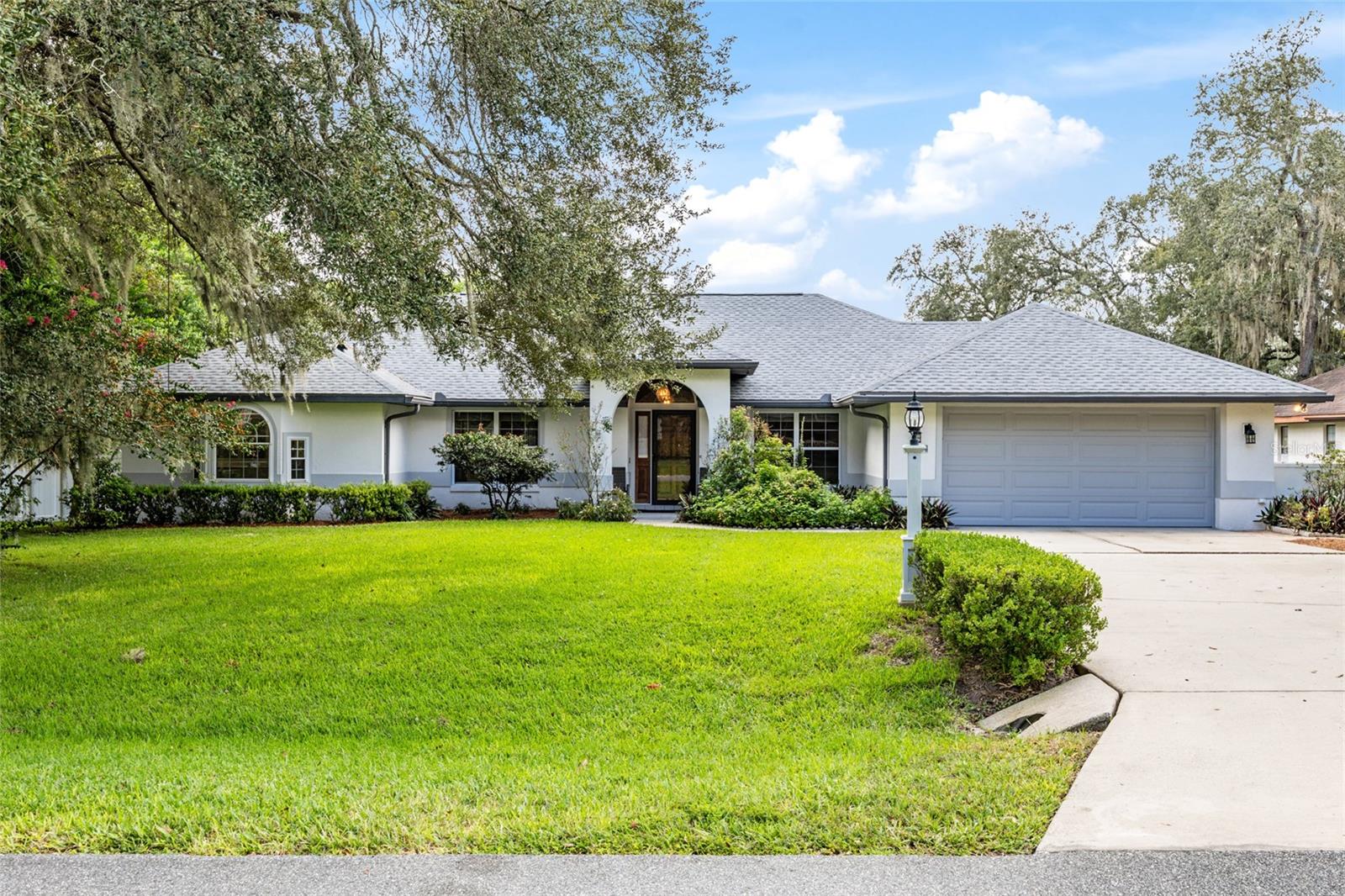 One or more photo(s) has been virtually staged. Stately 3-bedroom, 2-bathroom home with oversized 2-car garage on a large, manicured lot in Majestic Oaks is well maintained and ready for a new owner. Inside, you will find wide-plank hardwood flooring throughout the main living areas, with carpet in the bedrooms. The updated kitchen is a true showpiece, featuring gray cabinetry with dovetail drawers, crown molding, and soft-close features. All newer stainless-steel appliances, a breakfast nook, and a bar overlooking the great room make this space ideal for both everyday living and entertaining. The thoughtful split-bedroom floorplan provides privacy and functionality. The oversized primary suite boasts two walk-in closets, a cozy reading nook, and an elegant en suite bath complete with dual vanities, a jetted soaking tub, and a walk-in shower. Secondary bedrooms are generously sized, with the guest bath offering a large vanity area and direct access to the backyard. This home provides an abundance of flexible living space with two additional living rooms that can serve as a den, office, formal dining, or formal living area. The enclosed Florida room is perfect for a playroom, hobby space, or year-round relaxation. Practical updates include a new roof (September 2025), new water heater (Aug 2025), and HVAC (2014). The oversized 2-car garage easily accommodates extra-long vehicles and includes a separate workshop/storage space. Outdoors, the expansive fenced yard has lush landscaping and fruit trees, creating your own private oasis. Majestic Oaks is conveniently located to shopping, restaurants, medical and entertainment.