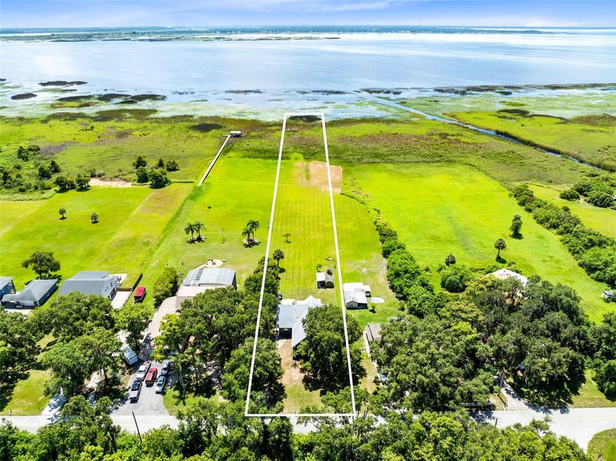 Experience the ultimate lakefront lifestyle in this unique 2-bedroom, 2-bathroom custom-built home nestled under majestic oak trees along the shores of West Lake Tohopekaliga—renowned for world-class bass fishing and bird watching. Constructed with solid poured concrete walls and a durable metal roof, this two-story residence offers 2,414 sq ft of comfort, craftsmanship, and natural beauty. Inside, the home features a beautifully renovated kitchen with granite countertops, a center island with cooktop, and custom soft-close wood cabinetry. Soaring wood-lined ceilings and tile flooring throughout add warmth and character, while large windows fill the space with natural light. Upstairs, a spacious loft overlooks the main living area and leads to a private balcony—ideal for morning coffee or sunrise views. Each floor includes a full bedroom and bathroom, offering flexibility for family or guests. Outside, there’s plenty of space to park your boat, RV, or any other outdoor toys, making this home as functional as it is beautiful. Just a block from the public boat ramp and with no HOA, this lakefront gem is a rare opportunity to live, play, and relax on your terms. For a 3-d tour of this home, click on Virtual Tour 2.