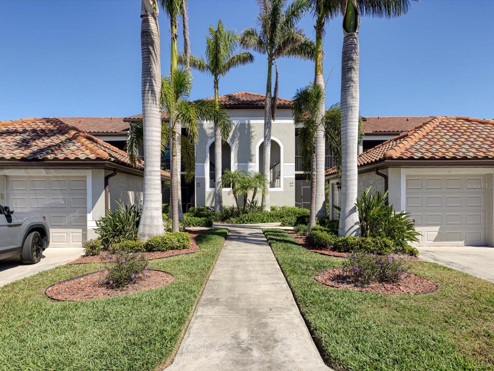 Step into an unparalleled blend of luxury and tranquility with this exceptionally pristine first-floor Veranda, a turnkey residence designed for those who seek the finest in resort-style living. Offering breathtaking, private conservation views, this exquisite home features two bedrooms, two bathrooms, and a versatile flex room, perfect as an additional bedroom, a home office, or a stylish den.
The gourmet kitchen is a chef’s delight, showcasing custom 42” wood cabinetry, gleaming granite countertops, a spacious breakfast bar, and an inviting eat-in area that opens seamlessly to a private front patio. Designed for effortless entertaining, this residence boasts multiple indoor-outdoor living spaces, including both front and back screened-in porches, where you can relax and unwind while surrounded by nature’s beauty. As an owner, you’ll enjoy exclusive golf privileges with a full Country Club membership, granting access to a 27-hole Arthur Hills-designed Championship golf course. Indulge in unparalleled amenities, including a grand 39,000 sq. ft. clubhouse, a world-class tennis club with eight lighted Har-Tru courts, pickleball, resort-style pools, two state-of-the-art fitness centers, a tiki bar, and an exquisite dining experience at the on-site restaurant. Nestled in a coveted location just moments from the pool and clubhouse, this residence offers effortless access to beautiful beaches and other popular destinations of Sarasota, St. Pete, and Lakewood Ranch, placing the best of Florida’s Gulf Coast at your doorstep. This is more than a home—it’s a lifestyle of sophistication and leisure. Experience the pinnacle of luxury living and schedule your private tour today.
