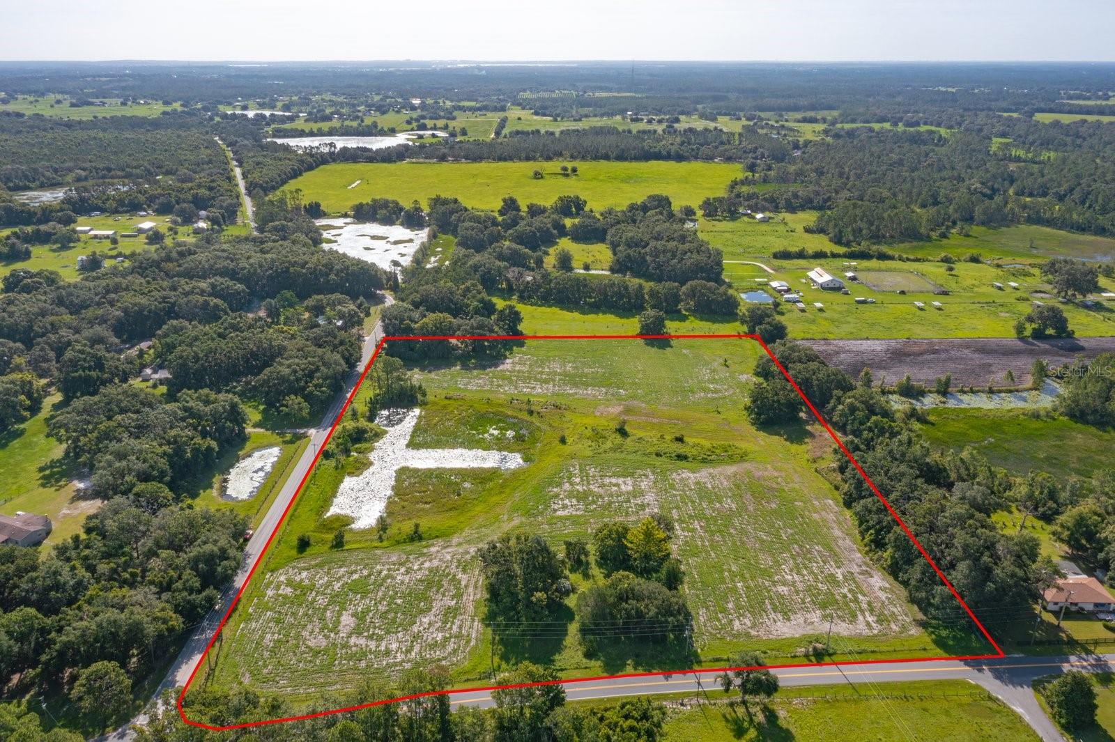 Incredible opportunity to own 12 acres of prime agricultural land on a corner lot, offering the perfect balance of rural functionality and future residential potential. This unique parcel features an active sod farm, a pond, and a designated residential building site already prepped with electricity and septic—ready for your dream home or manufactured housing.
With flexible agricultural zoning, the land is suitable for farming, livestock, nurseries, or even equestrian use. The corner location provides excellent access and visibility, ideal for both private enjoyment and business ventures. With the added pond feature you can build your dream home overlooking the pond and work on your farm! No HOA restrictions mean you're free to develop or use the land as you see fit.
This rare offering combines comfortable, flexible living arrangements with functional agricultural land, all within a manageable distance of main roads and rural amenities. Whether you're looking for an income-producing setup, family compound, or homestead with room to grow—this property offers the space, infrastructure, and zoning to make it happen. This property has so many options, just waiting for you to make it yours!