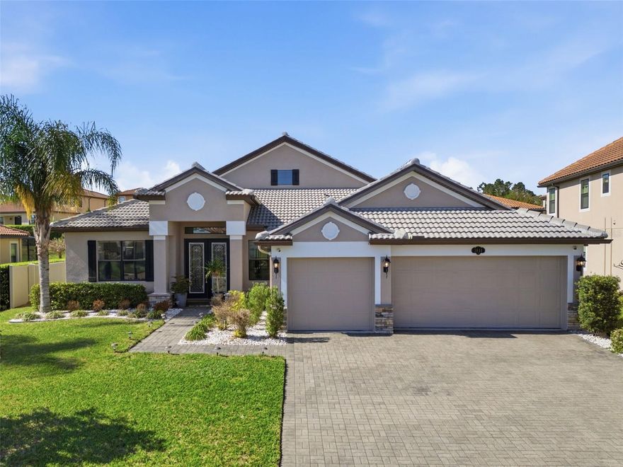 One or more photo(s) has been virtually staged. Welcome to Terralargo a gated community, conveniently located just minutes from Lakeland Square Mall. This 5-bedroom, 4-bathroom, 3-car garage home offers a functional layout and numerous upgrades, featuring a paver driveway, mature landscaping, and a newer barrel tile roof tile. Double glass entry doors open to high ceilings and wood flooring throughout the main living areas, with a formal dining room, private den/office, and an open-concept living space filled with natural light. The kitchen includes a large center island, quartz countertops, ample cabinetry, and updated appliances (2021), ideal for everyday living and entertaining. The spacious primary suite features a tray ceiling and en-suite bath with dual sinks, a garden tub, and a separate shower, while additional highlights include generously sized secondary bedrooms, a full pool bath, a separate laundry room, and an upstairs bonus room with a full bath. Outdoor living is enhanced by a covered and screened lanai with a custom pool and spa, creating a private setting for relaxation and gatherings. Recent updates include 2021 kitchen appliances, lighting, and ceiling fans; 2022 primary closet system; 2023 flooring, baseboards, interior paint, kitchen backsplash, and 3.5-ton downstairs HVAC; 2024 gutters, feature walls, landscaping, and office lighting; 2025 driveway sealing and security system; and 2026 vinyl privacy fence, exterior paint, and refreshed primary suite. Residents enjoy resort-style amenities, including a heated beach entry pool, spa, 24-hour fitness center, clubhouse, and sports courts (tennis, pickleball, basketball), conveniently located between Tampa and Orlando.  Schedule a showing today.