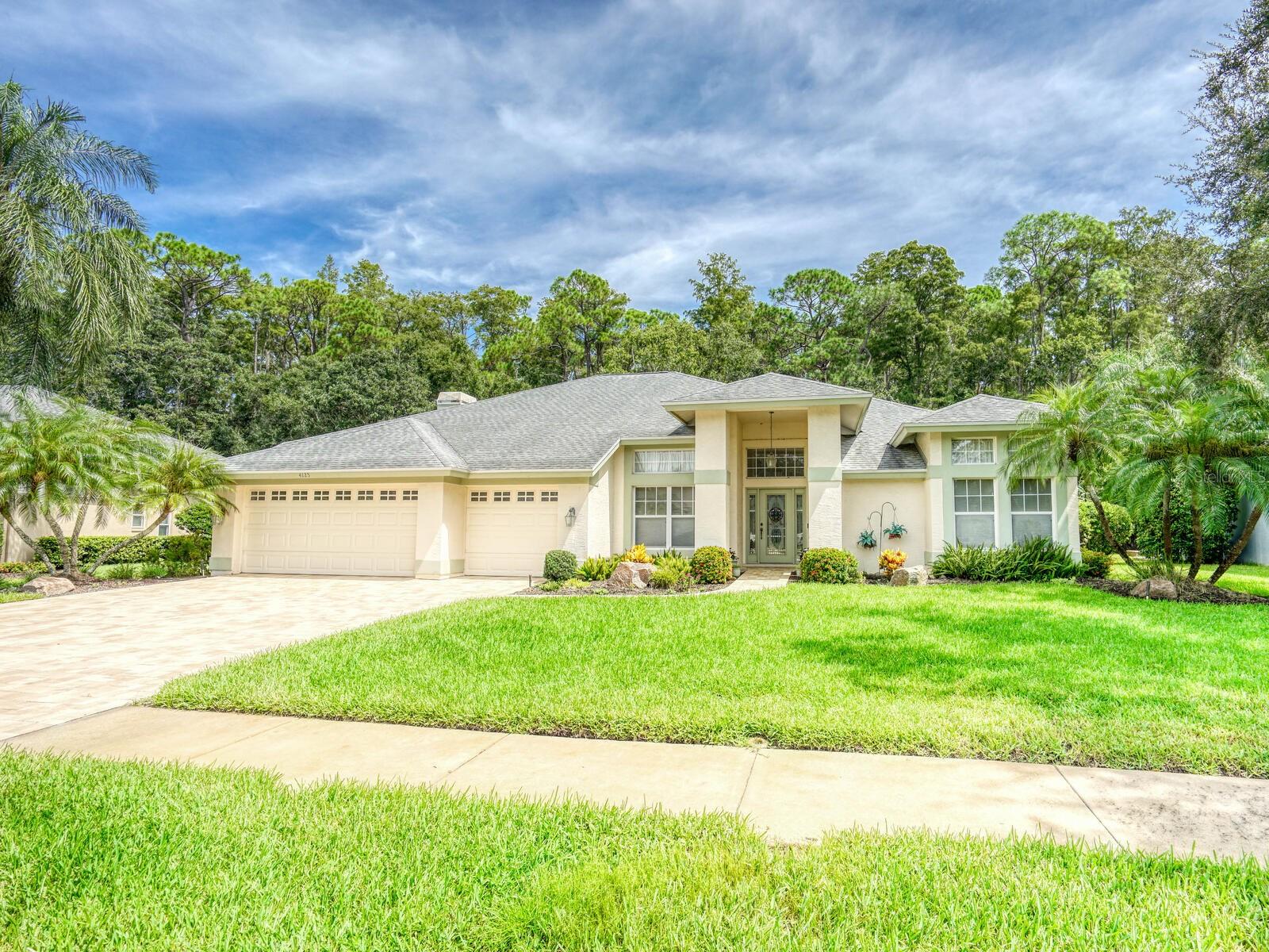 First time to the market, this four bedroom Arthur Rutenberg gem on a premium conservation lot is sure to impress! Located in Carlyle of Lansbrook, enjoy the tranquility and privacy this home has to offer as you look out over your oversized pavered lanai, outdoor kitchen, free form pool, a calming waterfall and the wooded view beyond. Kitchen with separate dinette area has stainless steel appliances, beautiful quartz countertops, breakfast bar and island is open to the family room with gas fireplace. Deluxe tiles with an intricate pattern run through much of the home. Formal spaces ideal for entertaining. Spacious master suite has extra large walk in closet and en suite bathroom. Split floorplan with two bedrooms sharing a jack and jill bathroom, a fourth bedroom with slider to the pool area, a pool bath and Den/office/bonus room on opposite side of the home. Roof 2019, HVAC 2021, Water heater and water softener 2023. Lansbrook, located in the East Lake Corridor of unincorporated Palm Harbor, is a highly desirable community with extensive walking paths, 2 parks, 2 playgrounds, private boat ramp with access to Lake Tarpon, dock and day slips. Zoned for well rated schools and convenient to shopping, airports, Pinellas Trail and John Chesnut Park. This home will not disappoint!