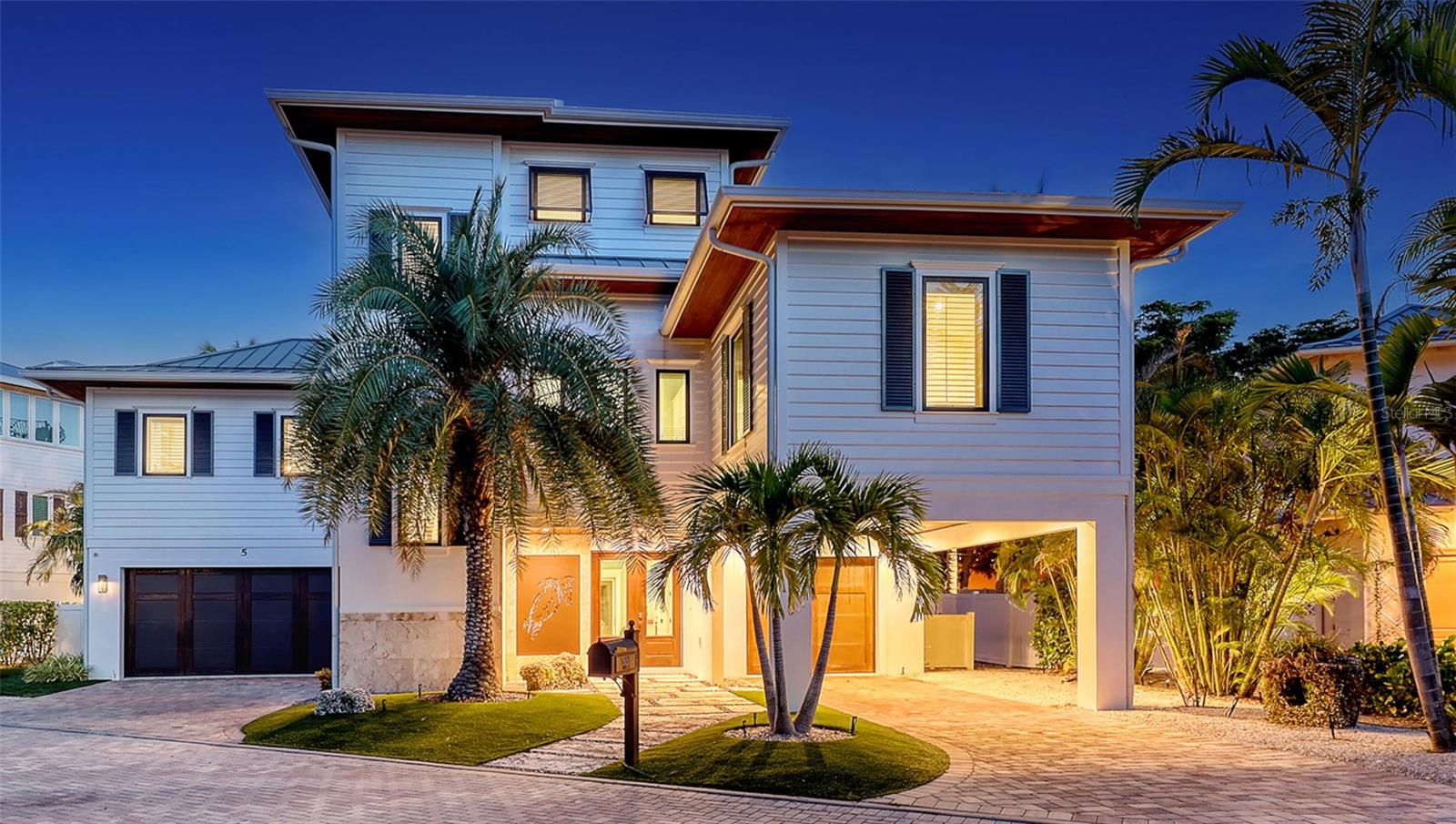 The Quintessence of Coastal Living: A British West Indies Masterpiece on Longboat Key - Where Architecture Meets Paradise. Offered turn-key, this exquisite 4,000+ sq. ft., 4-bedroom, 4.5-bath residence in Longboat Key’s prestigious Bonaire subdivision is a rare union of refined British West Indies architecture and the serene beauty of Florida’s Gulf Coast. Every inch of this home has been thoughtfully crafted to evoke a sense of effortless luxury—where sun-kissed days and gentle Gulf breezes blur the line between indoors and out. From the moment you step through the grand entrance, you’re embraced by light, texture, and tranquility. Creamy finishes, warm woods, and bespoke millwork elevate every space, while expansive windows and French doors invite in the turquoise glow of the Gulf and the soothing rhythm of coastal life. Main Level Elegance - The heart of the home features an open-concept chef’s kitchen with top-of-the-line appliances: a Wolf 6-burner gas range with custom vent hood, dual Asko dishwashers, Sub-Zero refrigerator/freezer, Wolf convection/microwave, and a 50-bottle wine captain. Quartz countertops, artisan pendant lighting, and a massive island with farmhouse sink make this space as beautiful as it is functional. The adjoining dining and great room flow effortlessly to an expansive balcony - perfect for indoor-outdoor entertaining. The main-floor Primary Suite offers tray ceilings, shiplap accents, dual walk-in closets, and a spa-inspired bath with soaking tub, double-entry stone shower, and sparkling stone vanities. Two additional ensuite guest rooms on this level echo the home’s airy, coastal elegance, and exceptional quality. Upper-Level Retreat - Ascend to a private owner’s sanctuary with dual custom closets and a lavish bath adorned with blue calcite counters, glass mosaic tile, and a freestanding tub. This level includes a substantial private balcony with access to the upper-level viewing balcony. The Observation Deck - Crowning the home is the ultimate vantage point—a “crow’s nest” with panoramic Gulf and Sarasota Bay views. It’s here you’ll end each day watching sunsets paint the horizon in unforgettable color. Resort-Style Outdoor Living - The pool retreat is an absolute showstopper - pocketing sliding doors reveal coral stone terraces, a resort-style pool with sun shelf and tiled cocktail table, a 10-person spa, and a fully equipped outdoor kitchen with seating for eight. The entire area is lined with an automatic insect elimination system to ensure you can enjoy the outdoors all year long. Optical lighting enhances the overflowing water features which seem to dance in the glow of firelight, creating the perfect setting for stargazing or nightcaps. The community provides private beach access and is close to world-class golf, tennis, fine dining, and the largest deep-water marina on the Gulf coast. This is more than a home - it’s a sanctuary, a work of art, and a lifestyle. Delivered exactly as you see it, fully furnished and ready to enjoy, this British West Indies masterpiece awaits the one discerning buyer ready to claim the very best of Longboat Key coastal living.
