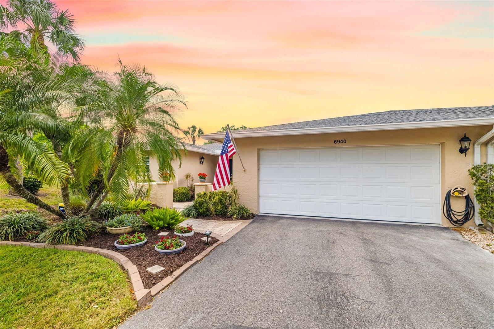From the moment you turn into this quiet, tree-lined enclave of Palm Aire, you'll feel a sense of arrival—and when you step into this immaculate end-unit condo, you'll know you’re home. Sunlight pours through impact-rated glass windows and sliders, dancing across the open living space and enclosed Florida room, where panoramic views of the garden and pool invite you to slow down and breathe.
This isn't just a 2-bedroom home—it’s a thoughtfully designed retreat with a flexible den that’s perfect as a home office, reading nook, or even a third bedroom with a simple closet addition. Every inch of this home speaks to care and quality, from the 2019 HVAC system and 2023 electrical panel to the two-year-old roof overhead. The spacious kitchen and newer appliances make everyday living a joy, while generous storage throughout means everything has its place—including your peace of mind. The oversized 2-car garage is a rare find, offering room for vehicles, bikes, beach gear, and more. Here, maintenance is effortless. The condo fee includes reserves, all exterior upkeep—including the roof—plus water, sewer, trash, and access to the shimmering community pool just steps from your door. And yes, your small furry companion is welcome too. Whether you choose to join the nearby Palm Aire Country Club or simply enjoy the lush surroundings, you’re perfectly positioned near dining, shopping, parks, and more. This is more than a condo—it’s your next chapter. Come see it today, and imagine the life waiting for you here.