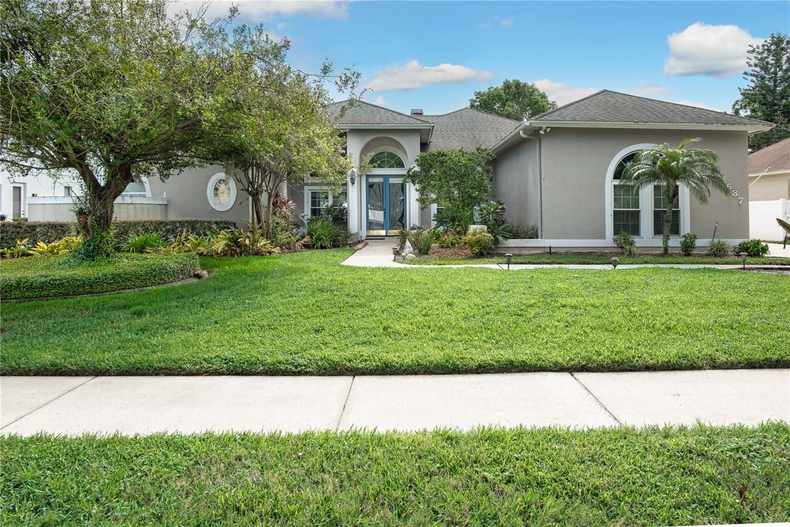 Exceptional opportunity to own a custom-designed home in the sought after community of The Gardens at Rio Pinar! This beautiful residence boasts 4 spacious bedrooms and 3 full baths featuring a thoughtfully designed 3-way split floorplan for privacy and convenience. The master retreat includes an extra den/office with French doors and ceramic tiled floor, perfect for remote work or relaxation. Enjoy an open and airy living space with vaulted/high ceilings that seamlessly overlooks your private pool screened with a fountain. The large covered patio includes an outdoor shower and kitchen area. A spacious backyard fenced, ideal for entertaining or family fun. Interior renovation/updates include a complete kitchen remodel, with utility/laundry/pantry including shelving and laundry sink, ceramic tile flooring 2021, appliance/ microwave new as of 2025, family room wood burning fire place remodel of hearth, mantel and wall 2019, formal living room remodel with ceramic tile floor 2022 and a custom built decorative stone wall installed in 2021. The master bedroom renovated in 2020 includes a tray ceiling, French doors to the additional den/office space with ceramic tile flooring. The hallway entrance from kitchen to 2nd and 3rd bedroom remodeled to an arched entry in 2019. The pool was converted to salt water with a pool pump with variable speeds in 2023. The covered patio and pool was screened in 2020. The vinyl fencing along the back yard portion of the property was replaced 2023. HVAC replaced 2023. Set on a quiet street with 0.31 acres, this property provides a tranquil environment and curb appeal. Additional features include a 3-car garage with workshop, side entry/drive, irrigation system and a beautifully landscaped yard. Conveniently located to shopping, dining and entertainment.