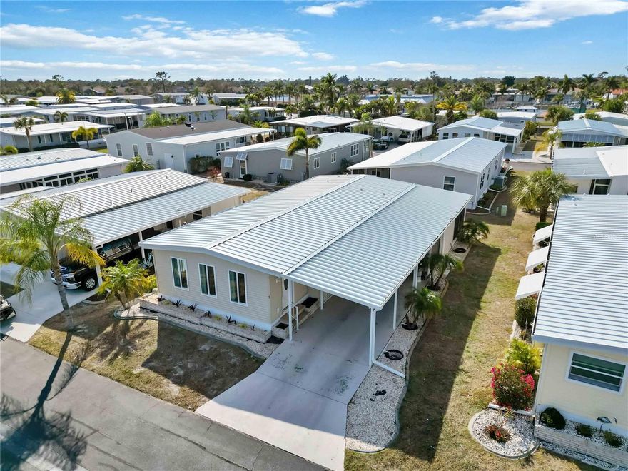 TURNKEY FURNISHED home featuring TWO PRIMARY SUITES located in the desirable waterfront (with INTRACOASTAL ACCESS) community of Alameda Isles, a 55+ community of manufactured homes that offers social activities, pickleball clubhouse, pool, hot tub, sauna, fitness center, library, card room and more! This beautiful home has all the recent upgrades including a new roof, carport, a fully remodeled Florida room with new windows, sheet rock, flooring & paint. As you enter the home, the "Florida room" has laminate flooring and serves as great additional living space for an office, hobby room or additional sitting area with ample natural lighting and sliding doors that lead into the living room. The recently painted interior and spacious open floor plan welcome you in. The main living areas feature easy to maintain laminate flooring & tile, and room for everyone inside with a large living room and formal dining area... all open to the kitchen offering an ideal layout for entertaining. The stunning kitchen features easy to maintain tile flooring, an abundance of white cabinets including storage space in island--and ample counter space, a chef's dream. Enjoy the luxury of both bedrooms having ensuite baths--one bedroom features a roomy walk-in closet, the same laminate flooring and the bathroom has a tub/shower combo. The second suite has laminate flooring, a large closet and ensuite with a double door shower and sizable vanity. Relax out back in the screened (20' x 11') lanai the covered lanai with your morning coffee or favorite book. Alameda Isles offers boat slips and storage for additional fees along with a plethora of amenities. Don't miss your opportunity to call this amazing home and one-of-a-kind community yours.