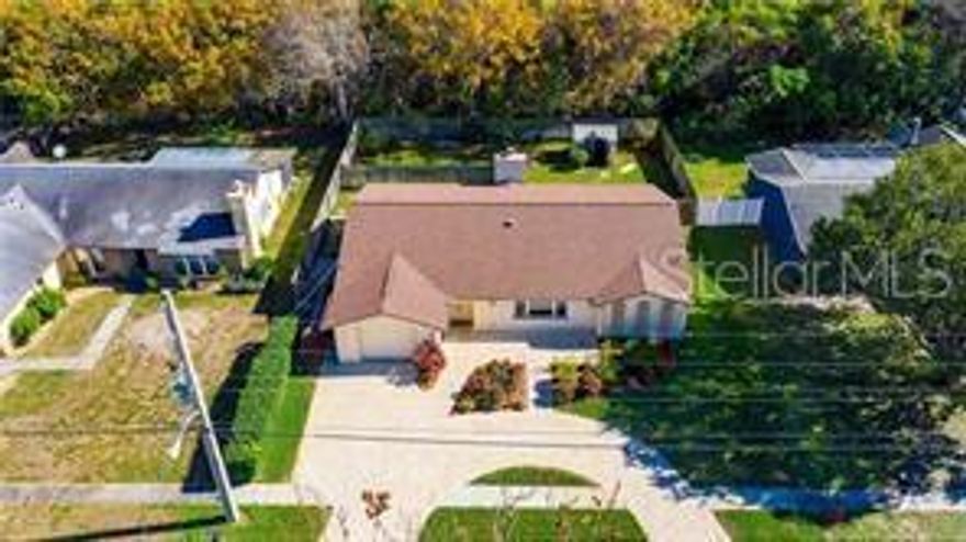 Pull up to the circular driveway all done in pavers, and you are greeted to a double door entry that leads you into the foyer. The home features 3 bedrooms, 2 baths split floor plan. Your kitchen features real wood soft close cabinets and draws. The kitchen has granite counter tops with large island facing the family room with a wood burning fireplace. The primary bedrooms has a walk in closet and on suite bathroom which features a shower with bench. The home has laminate flooring thru out and bathrooms are tiled. This lovely home is large with 1924 sq feet. There are 2 additional bonus rooms, tons of storage, and a inside laundry room. The back yard is fenced with area that is separate for your pet and the rest of the large yard has a section for entertaining, and a shed, you have no rear neighbors. Home is being sold as is. (There is above ground pool....will need maintenance) The garage has been mostly converted, however there plenty of storage. The owners are motivated to sell.