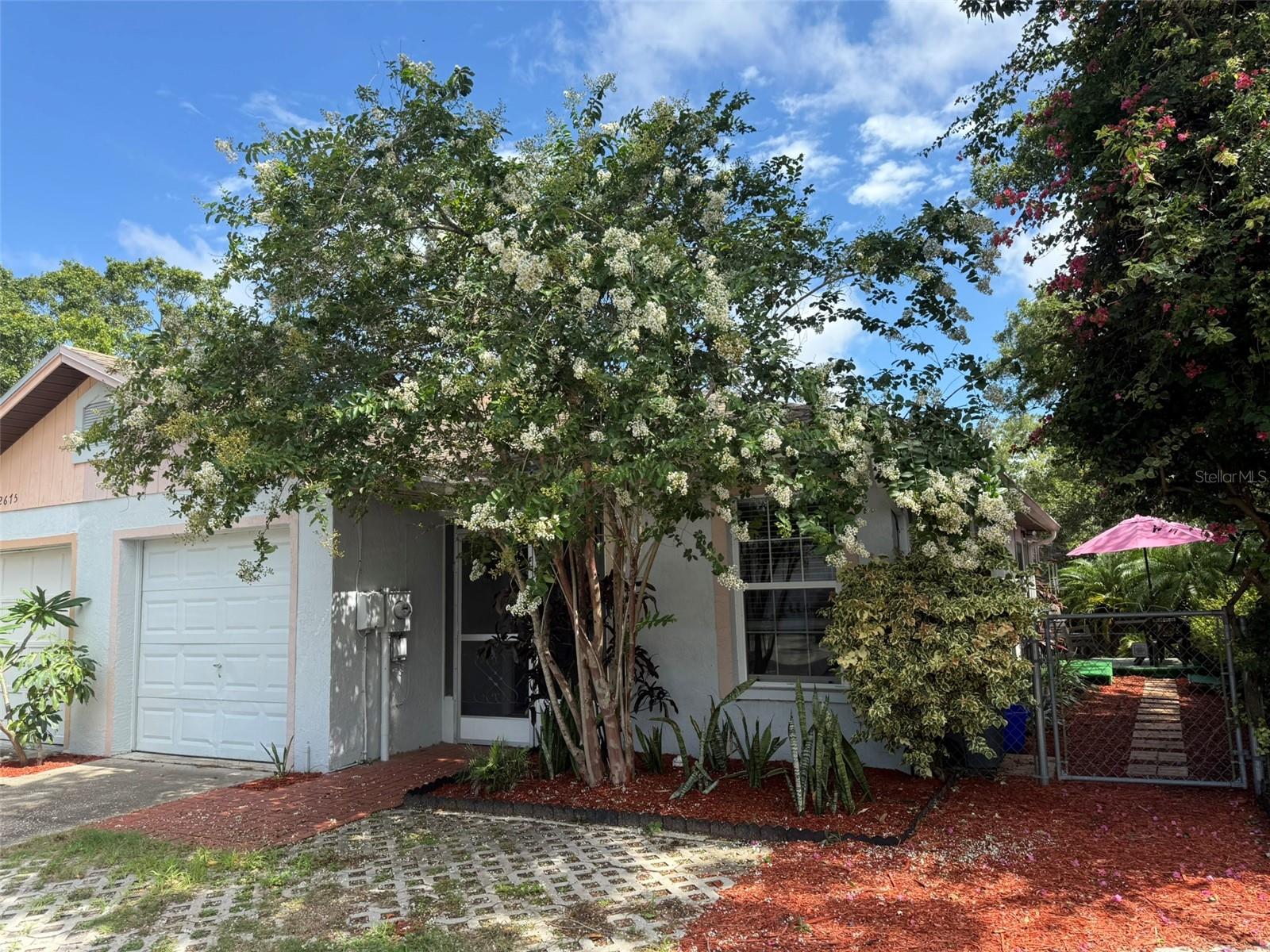 Welcome Home to Palm Harbor Paradise. This stunning 1 bedroom, 1 bathroom home is located in beautiful Palm Harbor, Florida. Upon entering, discover an open concept living space featuring vaulted ceilings and newer windows. The living room flows seamlessly into a chef-inspired kitchen, equipped with a stainless-steel stove, hood, and wood butcher block counters, plus an eat-in bar for dining. To the side, the converted garage offers incredible versatility. You can use it as a home office, den, library, with a large walk-in closet, skylight, and attractive wood flooring that add to the appeal. Down the hall, the primary bedroom impresses with double closets for ample storage, while the bathroom offers modern upgrades including newer vanity, fixtures, mirror, and a unique Bluetooth enabled exhaust fan with built-in speakers for spa-like relaxation. Enjoy true Florida living in the air-conditioned sunroom filled with natural light, or step through to the backyard deck that is perfect for dining surrounded by fenced greenery. Additional features include tile flooring throughout most spaces, attic storage, and convenient parking for two vehicles right outside your front door. Located in Palm Harbor’s sought after Lake St. George community, there are low HOA fees & no CDD'S! You are just a short drive to the beaches like Clearwater and the pristine sands of Honeymoon Island State Park plus there are many golf courses located nearby. It is conveniently located near historic Dunedin, Tarpon Springs, Palm Harbor and Safety Harbor shops and restaurants, and a short trip to Tampa and Saint Petersburg. Experience a home where every day feels like a vacation. Don’t miss your opportunity, schedule a private tour today and enjoy Palm Harbor living.