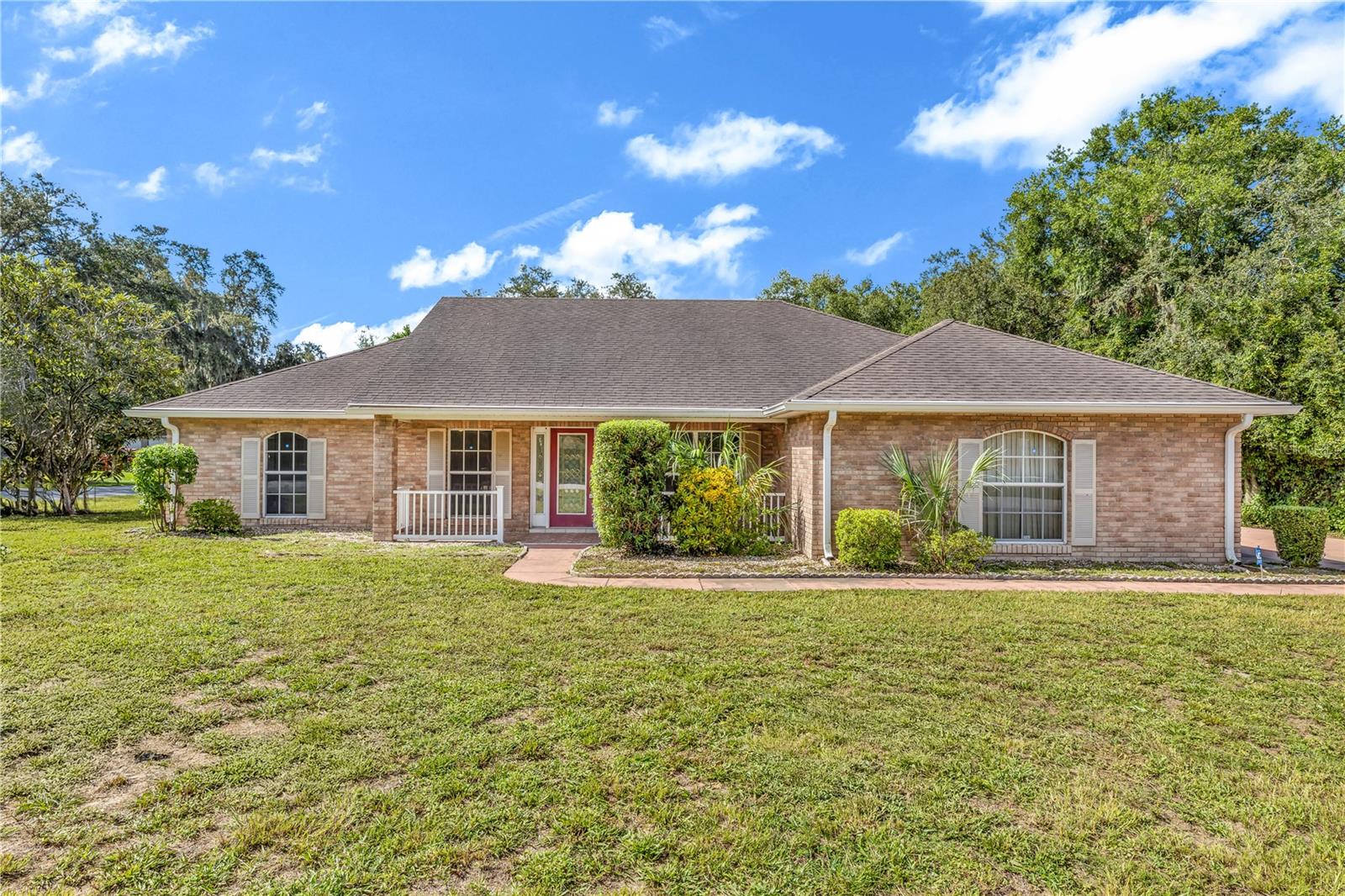 Welcome to this stunning 4-bedroom, 3-bathroom home on a spacious corner lot in Deltona, FL, perfectly situated between Orlando and Daytona Beach. This split-floor plan home boasts two master suites, ideal for multi-generational living or guests. Step inside to find a beautifully updated kitchen with solid wood white cabinetry, crown molding, decorative hardware, and included appliances, complemented by gorgeous bay windows. Enjoy new carpet, a 2022-updated AC, new gutters, and a washer/dryer for ultimate convenience. The exterior shines with a large front porch framed by decorative fencing, a huge fenced backyard with new vinyl fencing and decorative gates, perfect for pets or play, and a screened lanai plus an open patio for barbecuing. The oversized lot offers ample space for a pool and features a long driveway with front and side gates, ideal for parking larger vehicles or equipment. Located just 5 minutes from Publix, banks, and restaurants, and is less than an hour from Disney World and Daytona Beach. Priced to sell, this move-in-ready home won’t last long—schedule your showing today!