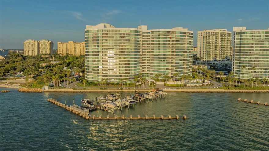 One or more photo(s) has been virtually staged. Direct Bayfront living in the heart of Sarasota at Condo on the Bay. This fully renovated 2 bed/2 bath residence features beautiful panoramic views of the Sarasota Bayfront with breathtaking sunsets over LBK and Ringling Bridge. Step into the inviting Great Room –  greeted by a wall of impact glass floor-to-ceiling sliding doors that seamlessly blend the outdoors in, opening to a spacious balcony overlooking one of two residents pools, just steps from one of the long piers and boat slips. Interior features include White Oak engineered hardwood flooring flowing throughout the Main Living space, complemented by custom built-in cabinetry and a dry bar with a wine refrigerator for easy entertaining. A chef’s delight, the modern kitchen features Elite Woodwork of Sarasota Cabinetry, stainless steel appliances including an induction cooktop and built-in wall oven and microwave, quartz countertops, Walnut wood backsplash, built-in pantry, and breakfast bar for casual dining. A conveniently located laundry closet with full-size stackable front-loading washer and dryer completes the kitchen. A true oasis, the master suite has serene water views, remote controlled Hunter Douglas shades, and plenty of storage space with a large walk-in customized closet plus a full entry wall of built-in cabinetry. The updated en-suite bathroom features dual floating vanities, modern floor-to-ceiling tile, a walk-in shower with frameless glass enclosure and multiple shower heads. The generously sized secondary bedroom boasts double built-in closets and a secondary bathroom with a floating vanity, walk-in shower with a frameless glass enclosure, and a built-in linen closet. New Ruud A/C in March 2023. Set directly on Sarasota Bay, the highly sought after community offers a lifestyle of sophistication and serenity. A range of amenities include staffed 24-hour security gated guardhouse, “sky lobbies” located on a number of floors throughout, two resort-style pools overlooking the bay, two fitness centers, tennis courts, pickleball courts, concierge services and boat/kayak docks with a fishing pier. This pet-friendly Tower II residence includes one assigned under-building parking space with secure access and storage. Just steps away from Sarasota Bay Park and the vibrant culture and arts scene of Downtown Sarasota, world-class dining, shopping and entertainment. A short drive to St. Armand’s Circle and Lido Beach. Don’t wait – it is time to experience a luxurious urban life from the 3rd floor of Tower II, in the Bayfront heart of Downtown Sarasota!