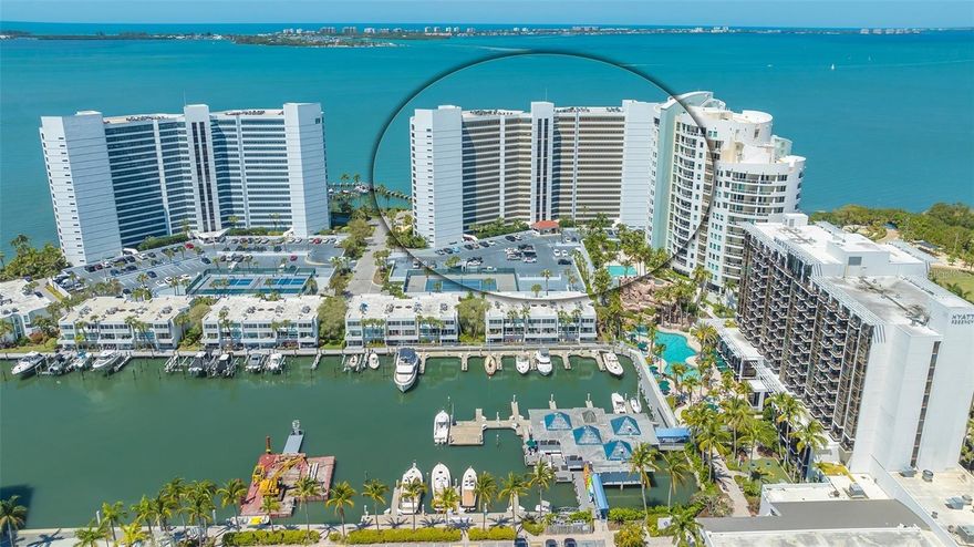One or more photo(s) has been virtually staged. Direct Bayfront living in the heart of Sarasota at Condo on the Bay. This fully renovated 2 bed/2 bath residence features beautiful panoramic views of the Sarasota Bayfront with breathtaking sunsets over LBK and Ringling Bridge. Step into the inviting Great Room –  greeted by a wall of impact glass floor-to-ceiling sliding doors that seamlessly blend the outdoors in, opening to a spacious balcony overlooking one of two residents pools, just steps from one of the long piers and boat slips. Interior features include White Oak engineered hardwood flooring flowing throughout the Main Living space, complemented by custom built-in cabinetry and a dry bar with a wine refrigerator for easy entertaining. A chef’s delight, the modern kitchen features Elite Woodwork of Sarasota Cabinetry, stainless steel appliances including an induction cooktop and built-in wall oven and microwave, quartz countertops, Walnut wood backsplash, built-in pantry, and breakfast bar for casual dining. A conveniently located laundry closet with full-size stackable front-loading washer and dryer completes the kitchen. A true oasis, the master suite has serene water views, remote controlled Hunter Douglas shades, and plenty of storage space with a large walk-in customized closet plus a full entry wall of built-in cabinetry. The updated en-suite bathroom features dual floating vanities, modern floor-to-ceiling tile, a walk-in shower with frameless glass enclosure and multiple shower heads. The generously sized secondary bedroom boasts double built-in closets and a secondary bathroom with a floating vanity, walk-in shower with a frameless glass enclosure, and a built-in linen closet. New Ruud A/C in March 2023. Set directly on Sarasota Bay, the highly sought after community offers a lifestyle of sophistication and serenity. A range of amenities include staffed 24-hour security gated guardhouse, “sky lobbies” located on a number of floors throughout, two resort-style pools overlooking the bay, two fitness centers, tennis courts, pickleball courts, concierge services and boat/kayak docks with a fishing pier. This pet-friendly Tower II residence includes one assigned under-building parking space with secure access and storage. Just steps away from Sarasota Bay Park and the vibrant culture and arts scene of Downtown Sarasota, world-class dining, shopping and entertainment. A short drive to St. Armand’s Circle and Lido Beach. Don’t wait – it is time to experience a luxurious urban life from the 3rd floor of Tower II, in the Bayfront heart of Downtown Sarasota!