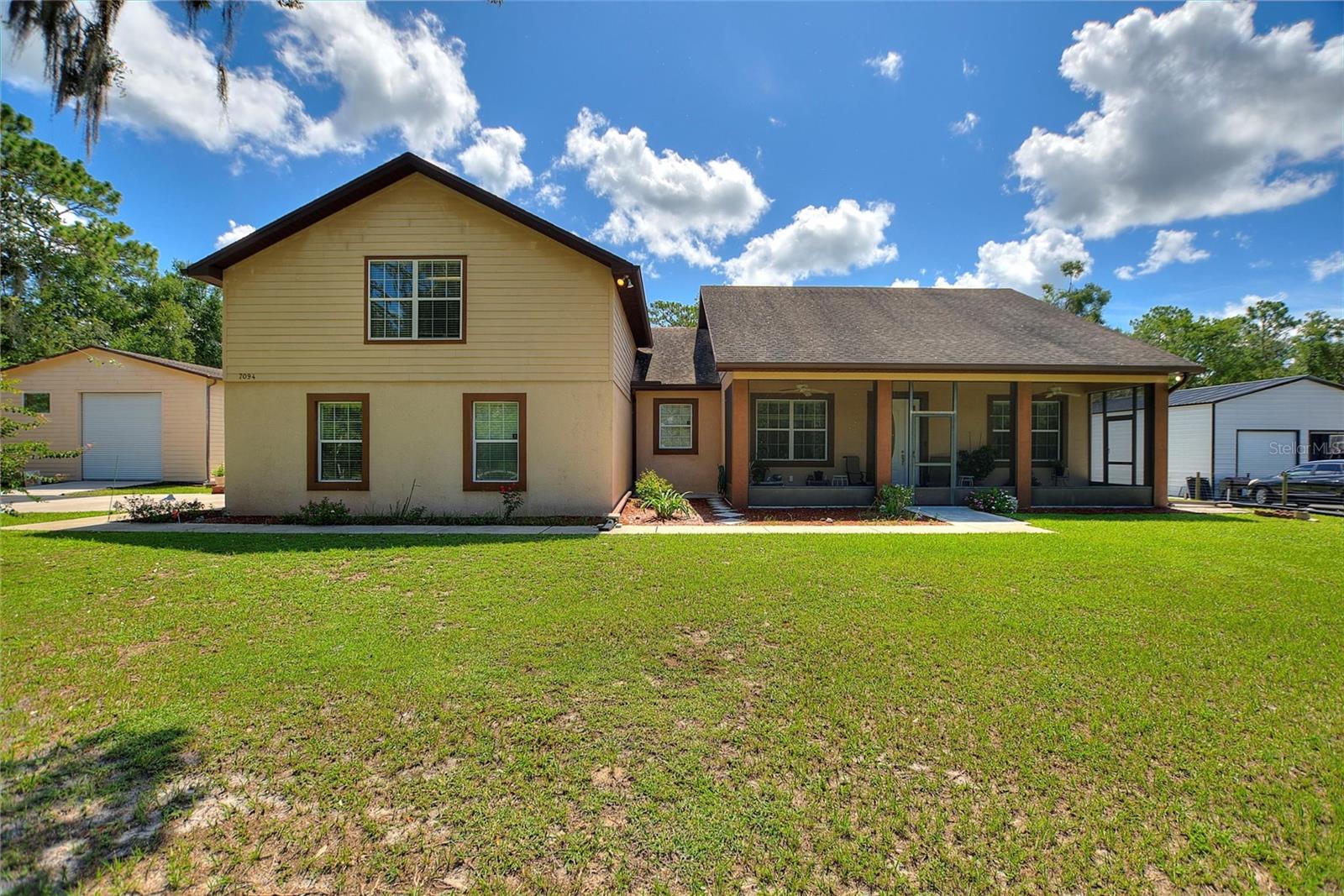 Welcome to your own slice of peaceful Florida living! This custom-built 3-bedroom, 2-bathroom home is perfectly situated on a fully fenced and gated 1.2-acre lot, offering privacy, space, and functionality for those who value both comfort and versatility. With a thoughtful split-bedroom layout, an open-concept floor plan, and multiple custom upgrades throughout, this property is a rare find.
As you enter the home, you're welcomed by bamboo flooring that flows through the main living areas, creating a warm and inviting atmosphere. The spacious living room opens to the formal dining room, breakfast nook and an expansive kitchen featuring granite countertops, custom cabinetry, and an oversized eating area. Whether you're entertaining guests or enjoying a quiet evening at home, this layout offers both flow and flexibility.
The master suite is a true retreat, complete with a large walk-in closet featuring custom shelving, bamboo flooring, and a luxurious en-suite bathroom with dual sinks, a granite-topped vanity, a jetted Jacuzzi tub, and a separate walk-in shower. The additional bedrooms offer versatile space, ideal for family, guests, or a dedicated home office. Bedroom 2 also features bamboo flooring, while Bedroom 3 is finished with durable wood laminate. The kitchen and dining room are finished with oversized tile flooring for style and easy maintenance.
Step through the French doors into the expansive screened-in back porch—perfect for relaxing in the Florida breeze or enjoying your morning coffee. Just beyond is your private backyard oasis, complete with views of lush greenery and mature fruit trees, including almond, tangelo, Meyer lemon, guava, avocado, and tropical additions like lemongrass, pineapple, and yuca.
The property features multiple functional outbuildings to suit a variety of needs. The oversized 30x40 detached garage/workshop is ideal for hobbyists or professionals, complete with a separate electrical panel and overhead door. This unfinished RV garage provides extra storage and includes a half bathroom—offering exciting potential for future use. The attached side-entry 2-car garage boasts an epoxy-like coated floor and a massive 20x25 open storage loft above, perfect for conversion into a studio, guest suite, or additional storage.
Additional highlights include a new HVAC system installed in May 2025, a tankless water heater (installed approximately 2020 per seller), an outdoor shower, and a light pole on the property for added nighttime visibility. The entire property is fenced and secured with an automatic gate for peace of mind.
Located in a tranquil area of large homesites with the charm of Old Florida, this home is just minutes from historic sites such as the Richloam General Store and Post Office. If you're looking for a well-maintained, move-in ready home that offers space, utility, and a connection to nature, this is the one you’ve been waiting for!