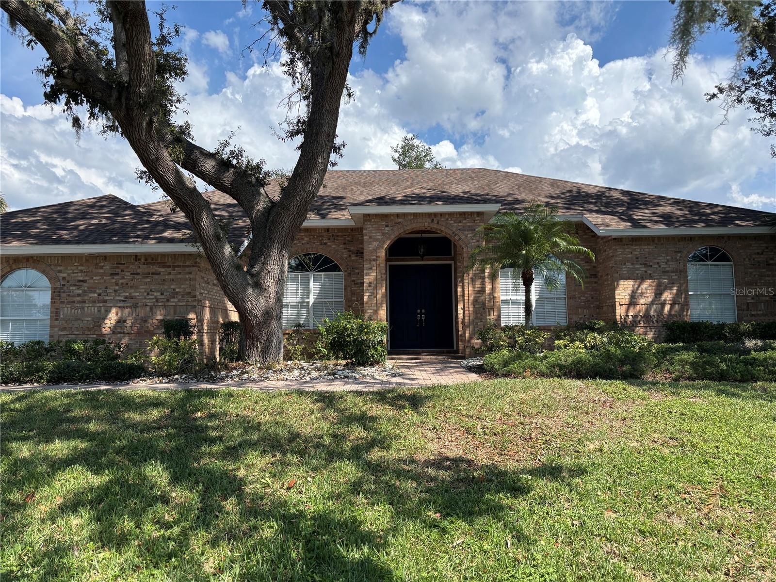 Elegant brick home in gated community on River Wilderness Golf Course! Welcome to your dream home! Nestled in a wonderful gated golf course community, this beautifully maintained brick home offers the perfect blend of luxury, comfort, and privacy. Large screened in patio is perfect for relaxing or entertaining. Surrounded by mature oak trees for added charm and shade. Stunning kitchen with solid surface countertops throughout. Updated primary bathroom featuring a separate soaking tub and walk-in shower. Enjoy the peace of mind of gated living while taking in the scenic beauty of tree-lined streets and fairway backdrops.