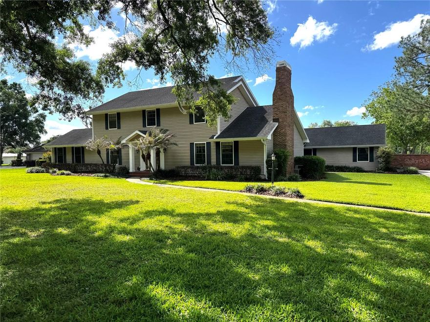One or more photo(s) has been virtually staged. Tucked away in one of Lakeland’s best-kept hidden secrets, this timeless two-story home on ACREAGE offers a rare blend of privacy, space, and convenience. Situated on an oversized lot, 1.5 ACRES along a peaceful lake, this property enjoys serene WATER & PASTURE VIEWS with NO REAR NEIGHBORS!! Located within a hidden enclave of custom homes on large, custom, beautifully maintained lots, this is truly country living while still being close to everything Lakeland has to offer.

Built in 1979, this large traditional residence spans approximately 4,300 square feet and features 4 bedrooms and 3 full bathrooms. The thoughtfully designed floor plan includes a downstairs bedroom and full bath, perfectly suited for an in-law or guest suite.

Inside, you’ll find a warm and inviting blend of formal and casual living spaces. The formal living room showcases elegant crown molding and custom built-in shelving, while the spacious family room features a cozy wood-burning fireplace. A dedicated library or office offers exceptional flexibility, complete with an oversized walk-in closet that could easily serve a variety of needs. Additionally you'll enjoy spending time overlooking the backyard and Pool area from a bright and airy SUNROOM.

The expansive kitchen is ideal for both everyday living and entertaining, with French doors that open to the screened-in pool and outdoor living area. Step outside to your private backyard retreat featuring a built-in grill area, fenced yard, and tranquil views of both the lake and surrounding pasture.

Additional highlights include generously sized bedrooms with ample closet space, including walk-in closets, fresh interior paint, and new carpeting in the bedrooms and family room. The home has been lovingly maintained and is move-in ready. A two-car attached garage, along with a separate WORKSHOP and additional storage area, provide plenty of room for hobbies and organization.

Conveniently located in the heart of Lakeland, you’re just minutes from top-rated schools, shopping, dining, and easy access to the Polk Parkway for commutes to Tampa and Orlando. Enjoy the charm of Lakeland’s lively downtown, known for its weekend farmers markets, local events, and vibrant community atmosphere. Affectionately known as the “Swan City,” Lakeland is also home to Florida Southern College and Southeastern University.

Opportunities like this are incredibly rare—schedule your private showing today before this one-of-a-kind property is gone.
