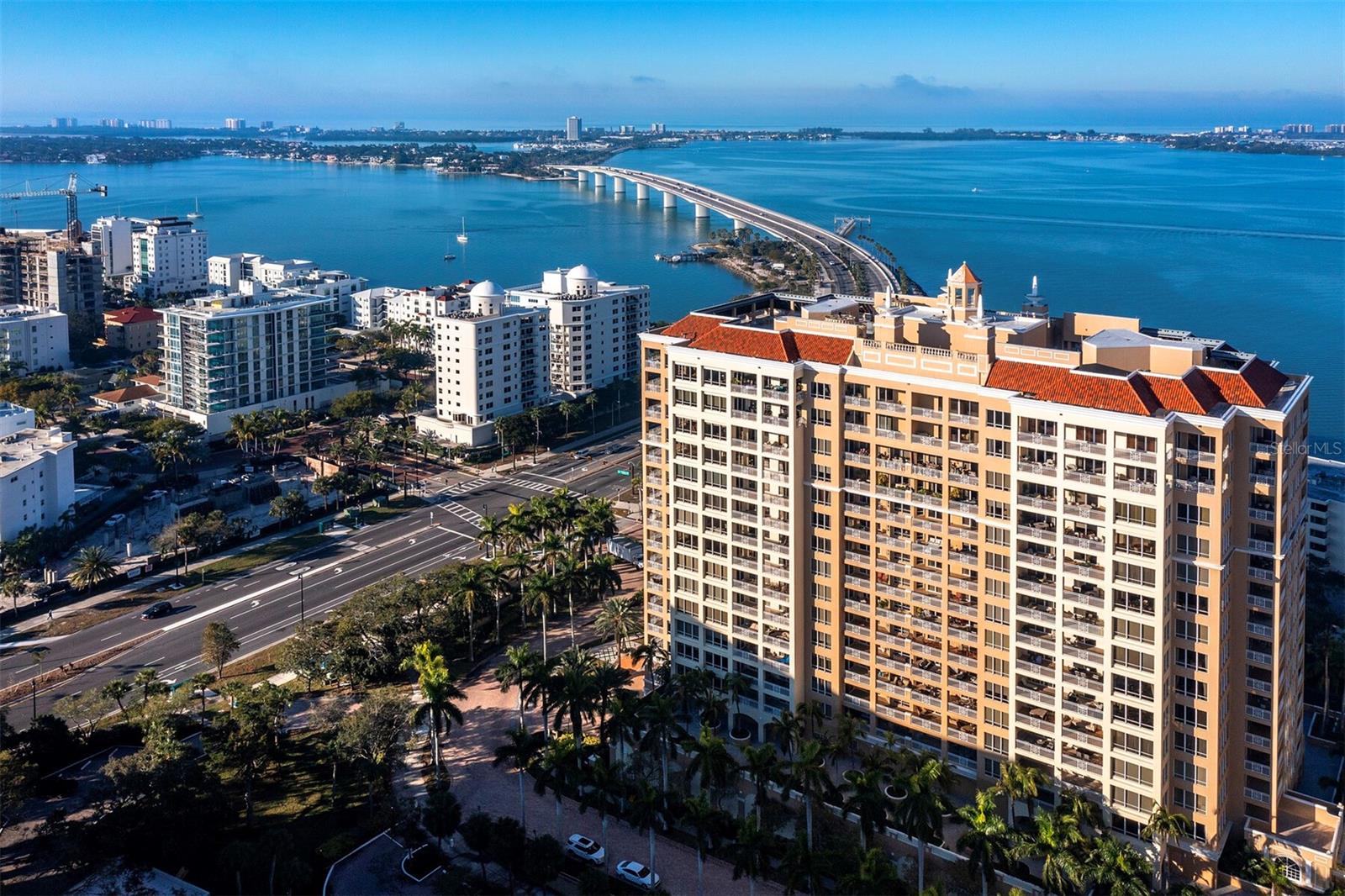 Perfectly positioned in the heart of the city, this direct bayfront residence exemplifies luxury living. As you enter the home from your private elevator, you will be greeted by comfort and luxury, all surrounded by endless views of Sarasota Bay and the Ringling Causeway Bridge. This spacious condo lives like a single-family home with 3 bedrooms and 3 full bathrooms. The residence offers two expansive terraces for outdoor relaxation and enchanting views of legendary Sarasota sunsets. Traverse across marble and rich wood floors amidst the warm glow of striking chandeliers that grace the entrance and living areas with an air of sophistication. Revel in the expanse of an open floor plan adorned with exquisite interior finishes and multiple dramatic walls of glass doors and windows. This inviting open and airy floorplan offers many flex space options, such as, the current third bedroom is being utilized as an office. Enjoy this well-appointed kitchen, which includes double ovens, Sub-Zero refrigerator, and abundant granite counters, while family and guests mingle in the breakfast room or on the second terrace. Ideal for entertaining, the great room with a dry bar and floor-to-ceiling walls of glass that open to a breathtaking 320-square-foot terrace affords striking southwest water views. A serene retreat awaits in the private owner’s suite with large windows and an adjacent balcony overlooking the bay. The spacious en-suite also features his and her walk-in closets and an opulent bathroom with a tub, walk-in shower, and two separate vanities. At the other end of the home, overnight visitors will be comfortable in the generously sized guest en-suite with a sliding door to the terrace. Convenience meets luxury with additional enhancements such as a sizable laundry room, tray ceilings, custom built-ins, and storage solutions. The residence comes with two parking spaces, one with an EV charging station and the other with power to add one. The Tower Residences offers the world-renowned lifestyle and signature services of The Ritz-Carlton, including 24-hour in residence dining. Beyond the walls of this gorgeous residence, embrace a lifestyle of leisure and wellness with access to a fully equipped gym, two spacious social rooms, massage room, business meeting room, movie theatre, a sparkling heated swimming pool, spa, an outdoor grill for al fresco dining. Being within walking distance of downtown amenities adds the appeal with trendy bars, gourmet restaurants, and chic boutiques nearby. Embrace the Sarasota lifestyle and elevate your everyday living to extraordinary heights.