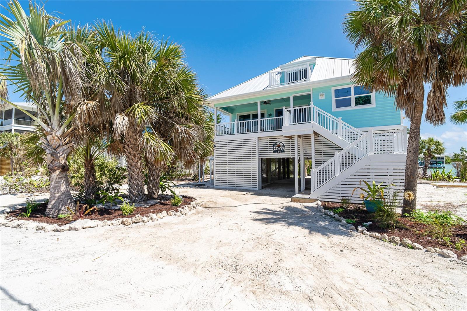 The perfect beach retreat across the sand road from the beach and the Gulf of Mexico!!! "Paradise Cottage" is aptly named for this cozy 3 bedroom, 2 bath home with many lovely appointments. Being sold turnkey furnished. Interior and exterior paint colors are green/blue hues that pull you into the serene environment of an island paradise. Kitchen has newer retro Big Chill appliances, wood cabinets and quart quartz countertops on the breakfast bar/island with space for eating in the kitchen as well. Bathrooms have decorative tile and cabinets. A complete hurricane mitigation report is available. Updates include: All CPVC piping and water heater replaced, preventative treatment of entire structure for termites (15 year warranty),new roof and foam insulations, 150 additional hurricane clips added to structure, Wind mitigation inspection inspection, all drywall replaced, windows and doors replaced with impact resistant glass and turtle glass, CertainTeed GlasRoc Sheathing installed under house, new kitchen cabinets, gutters, rear and front staircases and deck rebuilt with TREX, Staircase and deck and under house decking redone, exterior paint, electrical service panel, under house storage rebuilt with hardie, and septic pumped out and inspected. So it will be almost be like moving into a new home!! Don Pedro-Knight-Palm Island is a bridgeless, barrier island situated between Sarasota/Tampa to the north and Ft. Myers/Naples to the south. Accessible only via boat or a 4 minute car passenger ferry ride. Buy your "Paradise Cottage" today!!!!