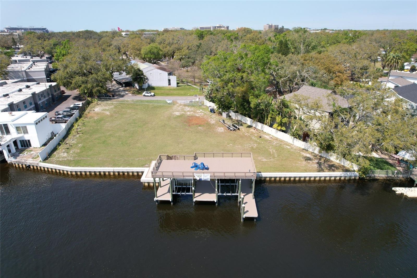 Experience the ultimate waterfront lifestyle with 219 linear feet of frontage on the scenic Hillsborough River, just minutes from Downtown Tampa. This rare .64-acre double lot offers ample space to build your dream home while enjoying breathtaking water views and premier boating access. Some key features include lot dimensions of 131' x 144' x 150' x 219'. New Seawall built with 12-ft vinyl sheets driven 6 ft into the riverbed for lasting durability. New Dock is Grandfathered structure with the capacity to accommodate 5-6 boats. Dual boat Lifts with DECO direct drive with 10,000 lb capacity each, featuring stainless steel cable systems. Premium Docking Materials: Composite 2' x 6' full-length deck boards for low-maintenance durability. Graded land ready for construction. Whether you're looking to build a custom waterfront estate or invest in prime Tampa real estate, this exceptional property offers limitless possibilities. Don’t miss this rare opportunity to own a piece of paradise on the Hillsborough River! You are minutes from Downtown Tampa, I-275, Raymond James Stadium, Legends Field, Tampa International Airport. Do not walk property without permission. No Trespassing. Must have an appointment to tour the land. Under surveillance. ** Adjacent Single Family Home is also listed for sale TB8357628. **