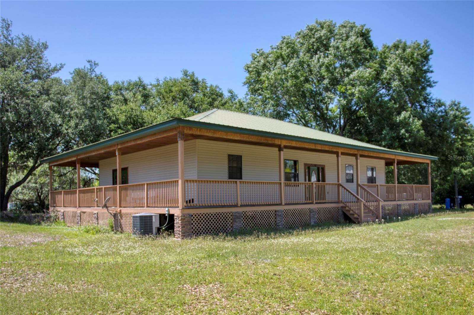 AMAZING PRICE! One or more photo(s) has been virtually staged. BRING OFFERS! Country Heaven, but close to everything Just 22 minutes to WDW! Already set up for your family or Airbnb. The setting is private and tranquil on 3+ acres just minutes from WDW and minutes to shopping, medical, and entertainment. The wrap-around elevated porch has entry points to the home at the front door, master bedroom, and breakfast nook. The interior feels huge with high ceilings and an open kitchen that combines with the living spaces to make a fantastic great room. The split bedroom plan provides separation and privacy. A complete interior fire sprinkling system and surround sound system are included. The separate garage is a massive 40' x 60' and will fit your RV, boats, and much more. The home has all of the modern features and is being sold completely furnished.
Not all furniture was installed at the time of photography new pictures will be posted.