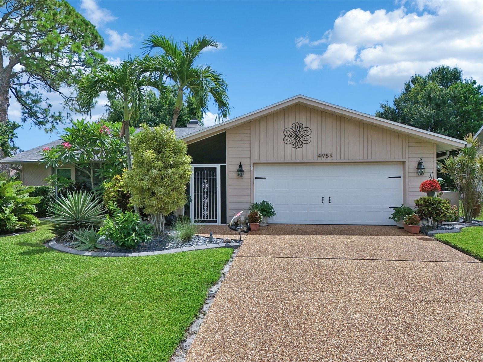 Welcome to this spacious and versatile single-family home located in the desirable Bent Tree Village, nestled behind the gates off Proctor Road on Lake Sarasota. This tropical oasis offers two true primary ensuites—perfect for multi-generational living—plus a guest bedroom and a flexible den/office/study space. The expansive open floor plan is ideal for entertaining, featuring a large open kitchen with granite countertops, an island, breakfast bar, and views to the screened pool area. The main primary suite boasts dual walk-in closets, a luxurious walk-in shower, dual vanities with granite counters, and a private water closet. The second primary suite also includes a walk-in closet and granite-topped vanity. French doors from the living area and both primary bedrooms open to a serene screened lanai with a sparkling pool and a covered outdoor entertaining area. Guests enjoy privacy with a separate bedroom and full bath tucked behind pocket doors. Additional highlights include a large laundry room with garage access, a two-car garage with an extended driveway, and a screened front entry for added privacy. Set on a beautifully landscaped lot with lush tropical surroundings and mature oaks, this home offers a tranquil setting in a community known for its spacious homes and abundant wildlife.