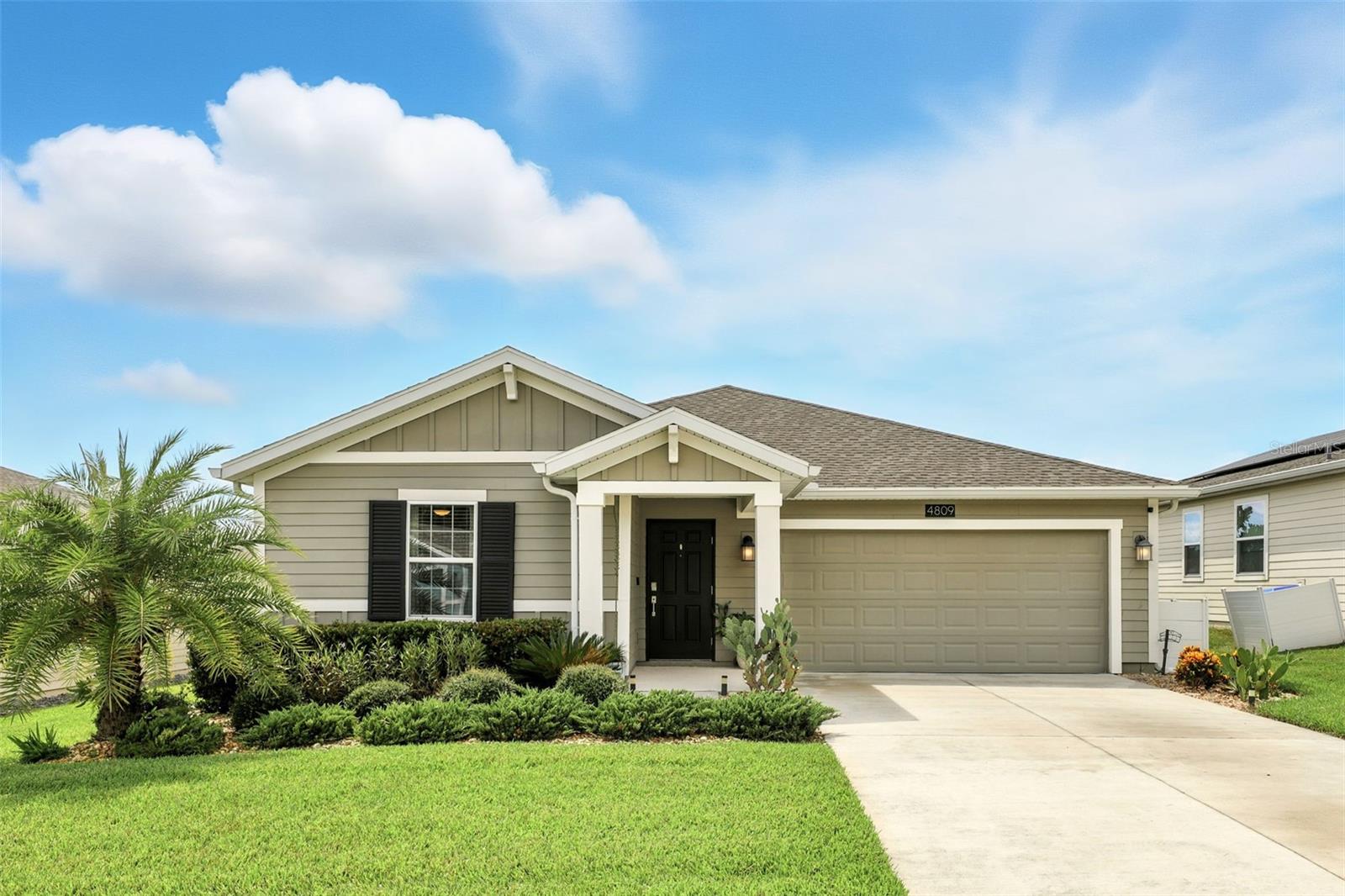 Welcome to your beautiful new home in charming Mount Dora. The open floor plan creates a perfect space for entertaining, with a seamless flow from the living area to the kitchen. The kitchen is a chef's dream, featuring STAINLESS STEEL APPLIANCES, QUARTZ COUNTERTOPS, and a convenient WALK IN PANTRY. The SPLIT FLOORPLAN provides ultimate privacy, separating the bedrooms from the main living areas. Step into the master suite, which offers a serene view of backyard. The master bathroom features double sinks and a CUSTOM WALK IN CLOSET, providing both luxury and ample storage. Outside, your own retreat awaits. The custom screened patio, complete with RETRACTABLE SHADES and BUILT IN FAN, is ideal for relaxing in any weather. Beyond the screen, an additional UNCOVERED PAVER PATIO with a BUILT IN CUSTOM GRILL NOOK is perfect for al fresco dining. Gardening enthusiasts will fall in love with the backyard. It's a lush and vibrant sanctuary, with a stunning variety of mature trees and colorful flowers, creating a truly serene and beautiful environment. Stoneybrook Hills is a beautiful GATED COMMUNITY packed with resort-style amenities: a sparkling pool, fitness center, tennis and basketball courts, baseball field, and playground. Schedule your private showing today and fall in love!
