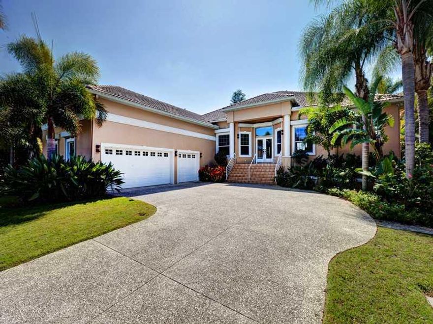 Located on Bay Island, the gateway to Siesta Key, this residence is perfectly positioned to offer residents the coveted waterfront lifestyle only found on the barrier islands of the Suncoast. Lush landscaping and attractive entry gates creates privacy while exquisite attention to detail apparent from the manicured grounds and spacious pool area to the appealing interior finishes brings this Coastal Modern residence to life. Expansive windows and sliding glass doors take advantage of the desirable southern exposure and endless views of Roberts Bay and the Intracoastal Waterway. Neutral paint colors, decorative light fixtures, travertine stonework and hard wood flooring work in harmony to convey an inspired breezy elegance throughout the home. The kitchen, set as the central core of the home, showcases custom cabinetry with large island and desk area, Baltic Brown granite and stainless steel appliances. Both the formal living room and casual gathering spaces open to the covered terrace where the alluring spa cascades water down to the open waterfront pool below. A mariner's paradise this Siesta Key home comes complete with dock featuring large vessel mooring, boat lift and jet-ski lift as well as swift boating access to the waters of Sarasota Bay and the Gulf of Mexico, where world renowned fishing and breathtaking sunsets await.