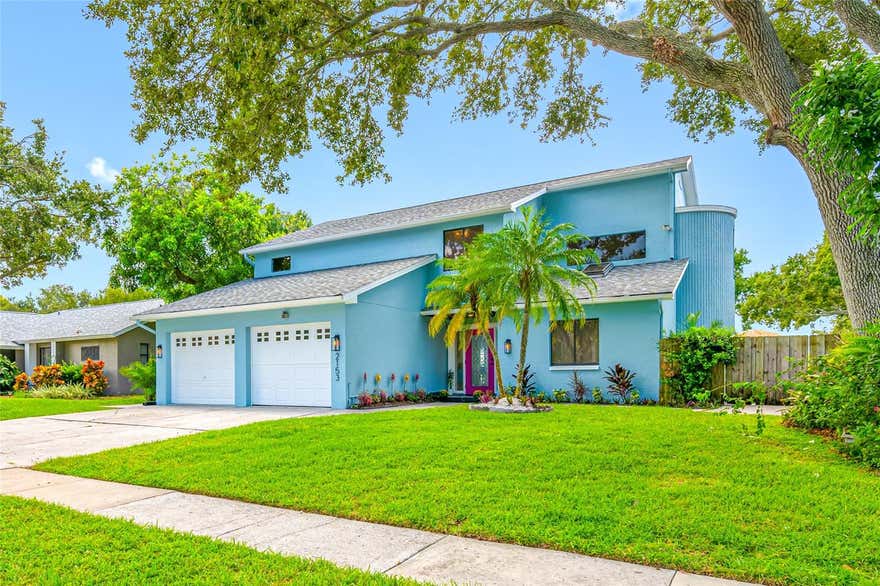 Welcome to a truly one-of-a-kind waterfront retreat in unincorporated Clearwater’s desirable Marla Groves Estates near Dunedin. Situated on over half an acre along the shores of Harbor Lake, this fully renovated and professionally furnished property offers an exceptional blend of luxury living, resort-style amenities, and proven income potential, while also offering the rare benefit of being located outside of a flood zone with no HOA restrictions. Extensively renovated and transformed in 2025 with upgrades including a new roof (including flat roof), newly resurfaced pool, and brand-new pool heater, this expansive residence features 4 bedrooms plus an enclosed sunroom/office, 3 bathrooms, and approximately 2,867 square feet of thoughtfully designed living space curated for both everyday comfort and unforgettable entertaining. Vaulted ceilings, hardwood flooring, designer finishes, two stunning stone fireplaces, and multiple indoor-outdoor gathering spaces create a warm yet elevated atmosphere throughout the home. Step outside into your own private lakeside oasis featuring a heated pool, expansive entertaining areas, mature landscaping, and direct access to Harbor Lake — a rare 40-acre spring-fed lake where boating, kayaking, and fishing are permitted. The oversized fenced lot includes abundant parking with room for guests, boats, RVs, and recreational vehicles.
The spacious primary suite and additional upstairs bedroom open to a large screened balcony overlooking the pool and lake, offering breathtaking sunset views and a true retreat-like experience. Whether used as a full-time residence, second home, luxury vacation property, or income-producing short-term rental, this property offers unmatched versatility. This home is currently operating as a successful high-performing Airbnb with Guest Favorite and Superhost status. Furnishings available separately for purchase, making this a potential turnkey opportunity for buyers interested in continuing short-term rental operations. Ideally positioned near Dunedin, Clearwater Beach, Honeymoon Island, MLB Spring Training fields, golf courses, shopping, dining, and Tampa International Airport. This exceptional property delivers the best of Florida waterfront living with privacy, flexibility, and lifestyle at its core. Rarely does a property combine this level of location, land, water access, renovation quality, and income potential in one offering.