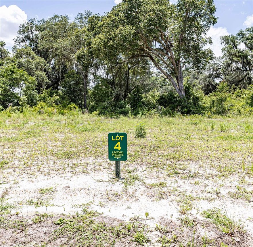 Experience luxury living infused with county charm in the exclusive, privately gated community of Oxford Preserve Estates.  With only 20 estate lots set on 5-8+ acre parcels of land, each is unique featuring pristine, wooded land highlighted by majestic native Live Oaks, graceful palmetto, and scrub oaks. Designed with both elegance and natural beauty in mind, all utilities are discreetly placed underground, preserving the serene landscape while offering modern convenience. There is no set timeframe for building your custom dream home, giving you the freedom to choose your own builder and craft a residence that perfectly suits your lifestyle. Public utilities are robust and reliable, including high-speed Spectrum internet and dependable SECO electric service, while private utilities such as well and septic systems are managed individually by each lot owner. Home designs are thoughtfully mandated to ensure spacious living, with one-story homes requiring a minimum of 2,400 square feet and two-story homes needing at least 1,800 square feet on the first floor. Adding to the appeal is an affordable HOA yearly assessment of less than $800, which helps maintain the community’s pristine condition. Ideally located, this neighborhood offers true Florida living at its finest, with the convenience of being less than a 10-minute drive from essential amenities including The Villages Charter School, Super Walmart, Publix, Costco, Chick-Fil-A, Lake Sumter Landing, Home Depot, Lowes, and churches.