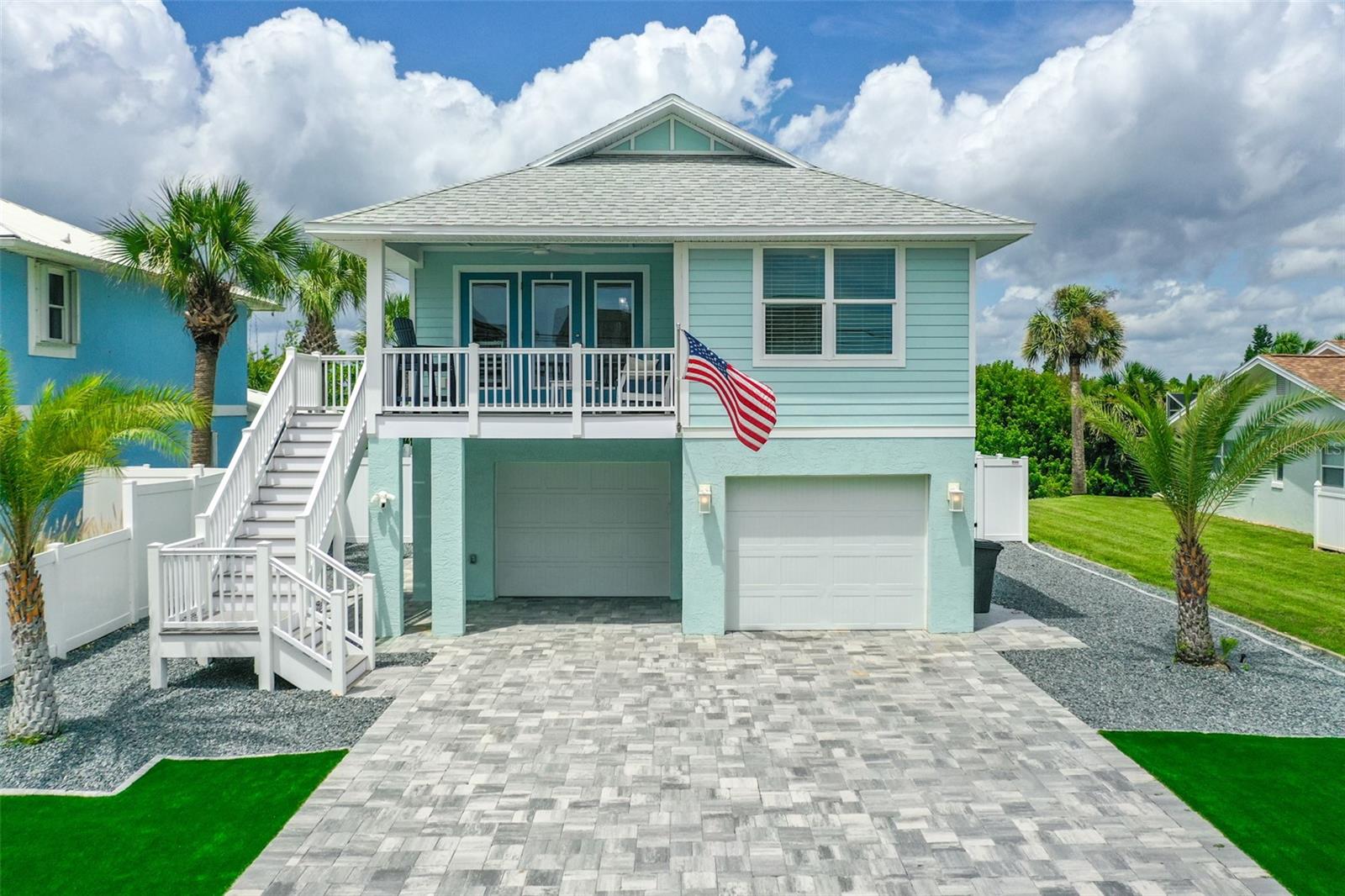This gorgeous 3-bedroom, 3-bath POOL home has been completely updated from roof to floors, sits on a high and dry S Central lot so no flood worries, and has ocean views! Just one block from the beach, it offers the perfect coastal lifestyle. The recent upgrades are impressive, with a stunning brand-new in-ground pool with paver surround, 2 putting greens, paver driveway, walkway, and back patio, as well as wind-rated garage doors and new openers. Inside, you'll find a modern and inviting space with new interior doors, trim, baseboards, and hurricane impact doors and windows throughout. The Cortec LVP flooring adds a touch of elegance, and tile flooring in the laundry and downstairs bathrooms is both practical and stylish. The lighting fixtures and fans have been replaced, along with an upgraded electrical panel, a brand-new roof, and a new HVAC system for comfort and energy efficiency. The kitchen is a chef's dream, featuring custom cabinets with soft-close drawers, Cambria Quartz countertops, a custom vented range hood, and a pantry with soft-close pull-out drawers. The custom tile-back splash and new induction stove and convection oven complete this culinary haven. The property has been beautifully transformed with exterior Hardy Board siding, fresh paint inside and out, and new landscaping. A custom stair railing adds a modern touch, and an exterior storage shed provides additional space for your belongings. This stunning renovation represents an investment of almost $350,000, making it a truly exceptional place to call home.