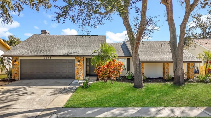 Welcome to a beautiful, newly updated and meticulously maintained 4 bedroom, 2 bath, 2 car garage pool home in Northwood West of Countryside! Located on a beautiful street with mature trees, this home boasts 2316 square feet of living space. Remodeled from top to bottom, this home is move in ready! With head turning curb appeal, this home combines location with luxury living. From the moment you step onto the property, you will notice the contemporary tiled entryway, lush landscaping and new exterior paint. As you enter the bright foyer, you will immediately notice the new luxury vinyl plank flooring, gorgeous light fixtures, huge open floor plan, vaulted ceilings and cedar beams. The open layout centers on a newly renovated eat-in kitchen, flaunting white shaker cabinets, gold pulls, quartz countertops, oversized sink with commercial faucet, new stainless appliances, new lighting and a completely custom wood range hood. Enjoy the beauty of the fireplace as you gather in the kitchen and around the oversized island, which is sure to be great for entertaining. You will also find a built in bar with custom tile and shelving, new cabinets and lighting. With sliders throughout the home spilling out to the pool, you will be sure to enjoy seamless entertainment. This residence offers a huge tiled lanai, a newly resurfaced pool and huge fenced in yard. Entering the guest bath you will notice custom designed tile, an oversized double sink vanity and beautiful new fixtures. In addition to the family room and eat in kitchen, you will also find a formal living and dining room so you can be sure to have space for friends, family and guests. Just beyond this point you will notice a huge master suite with oversized dual vanity bathroom and walk in closet. With stunning vanities, tile, and lighting, this master suite will be sure not to disappoint. In addition to the features of the home, the laundry room is completely remodeled with custom tile and shelving, brand new washer and dryer, and a newly installed cabinet and sink for convenience. Inside the 2 car garage you will find it too is completely updated and includes a newer garage door and door opener. Roof replaced in 2020, water heater 2025, new water softener, 2025 electrical panel upgrade, vinyl windows with new window treatments, 2024 newly installed irrigation system with well pump, heat/ac in great condition, epoxy garage floors, and all appliances are brand new with warranty. Conveniently located with access to all the things you love to do. This home won't last!! Schedule your showing today.