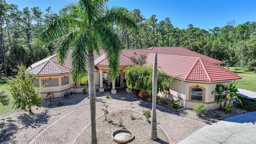 Experience the epitome of luxury and privacy in this exquisite estate nestled on over 3 acres of pristine Florida landscape. Tucked away on one of North Port’s most sought-after streets, this custom-built residence offers an extraordinary blend of elegance, comfort, and functionality—crafted for those who desire space, sophistication, and serenity while remaining just minutes from shopping, dining, and Florida’s Gulf Coast lifestyle.
From the moment you arrive through the gated entrance and palm-lined drive, you’ll feel the sense of arrival only a true estate can provide. Step inside to soaring 12-foot tray ceilings, sun-drenched living spaces, and a seamless open layout designed for effortless entertaining. Every room was intentionally designed with space and flow in mind—offering a room for every person and every occasion, from elegant dinner gatherings to quiet retreats.
The chef’s kitchen is the heart of the home, boasting rich wood cabinetry, high-end stainless steel appliances, an expansive center island, and panoramic views of the lanai and pool. Oversized sliding glass doors create a fluid indoor-outdoor connection, opening to an outdoor oasis that feels like your own private resort. Enjoy a fully screened saltwater pool and spa surrounded by lush nature, and a spacious covered lanai ideal for hosting under the Florida sun.
The primary suite is a true sanctuary, featuring a spa-inspired bath with dual vanities, a walk-through shower, soaking tub, and an oversized custom closet that rivals a boutique. Additional bedrooms are generously sized, each with private or semi-private baths and abundant closet space. The upstairs bonus room adds endless flexibility—perfect as a game room, home theater, fitness studio, or guest suite.
For hobbyists, entrepreneurs, or car enthusiasts, the oversized garage and extended driveway provide ample space for vehicles, storage, or creative projects. The property’s sprawling 3 acres offer complete privacy while still allowing easy access to I-75, Wellen Park, local beaches, and all of North Port’s amenities.
Whether you envision this as a multi-generational retreat, entertainer’s paradise, or peaceful escape surrounded by nature, this home delivers a lifestyle that is both expansive and refined.
Luxury, privacy, and possibility—all in one address. Welcome to 6345 Ponce De Leon Blvd.