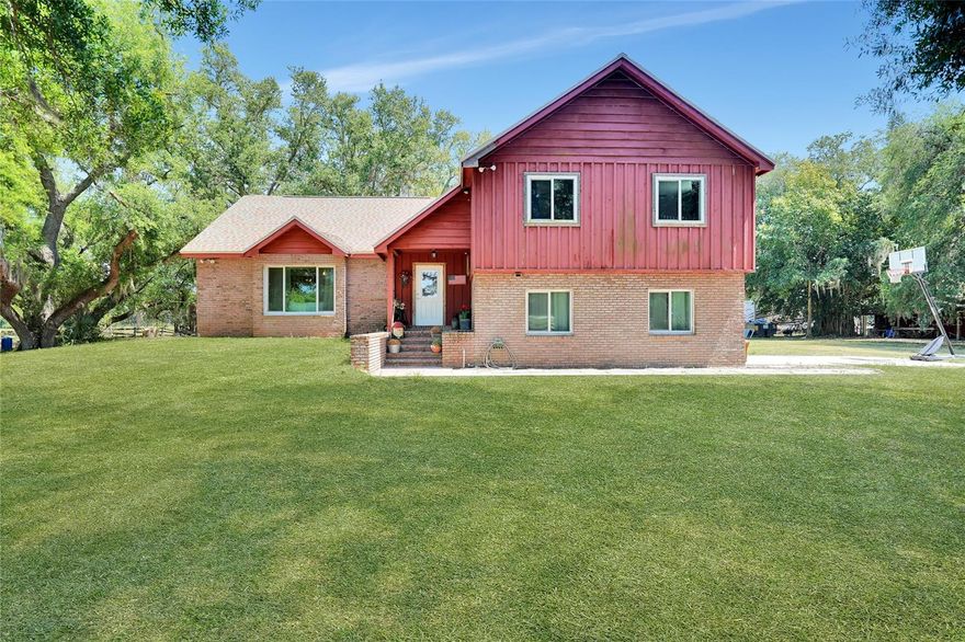 Saddle up and bring the whole farm—this 15-acre slice of country paradise is ready for you! This 4-bedroom, 2-bathroom home is all about wide-open spaces, fresh air, and plenty of room for your animals to roam. Major updates? Already handled! New roof (2022), hurricane impact windows and doors (2022), and a brand-new kitchen (2021). Plus, with newer A/C units (2021) for both floors, this home is as practical as it is charming. Inside, you'll find a welcoming foyer, a cozy family room, a kitchen with a sunny breakfast nook, a separate formal dining room, and a flexible bonus space—perfect for whatever your country heart desires. Large windows flood the home with natural light, bringing the beauty of the outdoors right inside. And speaking of the outdoors… Animal lovers, get ready! This property is fully fenced and cross-fenced, featuring a stable barn with power, an office, a half bath, a tack/feed room, and even an RV hookup (30/50 amp) with its own well and septic. Rolling pastures shaded by mature oaks make the perfect setting for horses, cattle, goats—you name it! If you've been dreaming of the country life with room to ride, roam, and relax, this is the one. Bring your animals, bring your toys, and make this farmstead your forever home. Call today for a private tour!