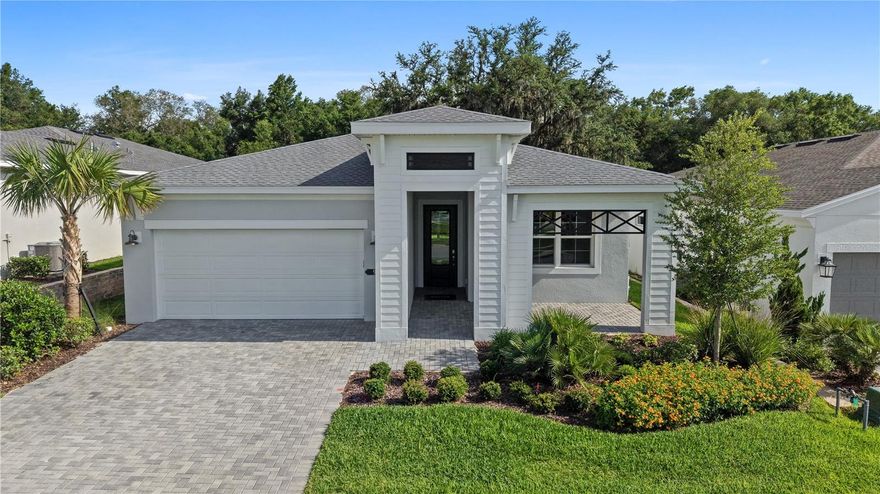 One or more photo(s) has been virtually staged. Move in Ready! Beautifully upgraded one-story coastal-inspired Morgan model offering 3 bedrooms, 2 bathrooms, and a 2-car garage with a 4’ extension across 2,289 sq. ft. of thoughtfully designed living space. This open-concept home features impressive 16’ wide x 8’ tall sliding glass doors that create seamless indoor/outdoor living. Enjoy a spacious lanai with a 5’ privacy wall and summer kitchen rough-in, perfect for entertaining. Interior highlights include porcelain tile flooring throughout the main living areas and kitchen, laminate wood plank flooring in the Owner’s Suite and flex space, tile-to-the-ceiling showers in all bathrooms, a semi-frameless shower enclosure in the Owner’s Bath, designer light fixtures, glass front door, washable flat interior paint, Bath 3 shower upgrade, and laundry tub rough-in. Coastal Elevation C adds exceptional curb appeal to this move-in ready home. Cresswind at Hammock Oaks, a new active 55+ community by Kolter Homes, is situated in Lady Lake, FL, famously known as the “home of lakes and sunshine.” Located near The Villages the community is only minutes from Leesburg and convenient to Orlando. This gated community in Central Florida features Cresswind's national award-winning "Set Yourself FREE" lifestyle program based on the cornerstones of Fitness, Relationships, Education and Entertainment. The resident-only clubhouse with a state-of-the-art fitness center and offers 55+ neighbors a place to gather and participate in social activities facilitated by a full-time Lifestyle Director. Outdoor amenities will include pickleball & tennis courts, walking trails, resort-style pool and spa, pool, event and entertainment areas. To learn about this home built around you, contact a Cresswind at Hammock Oaks New Home Guide.